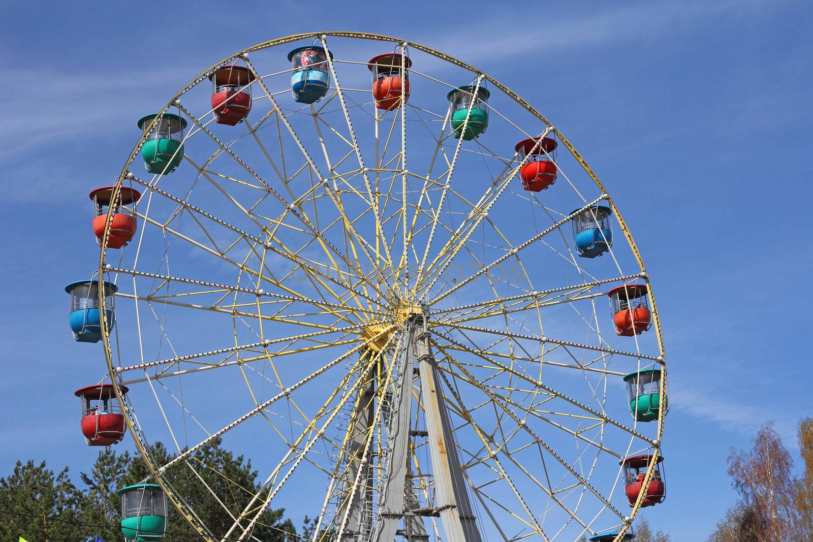 Atraktsion colorful ferris wheel against the blue sky by aarrows