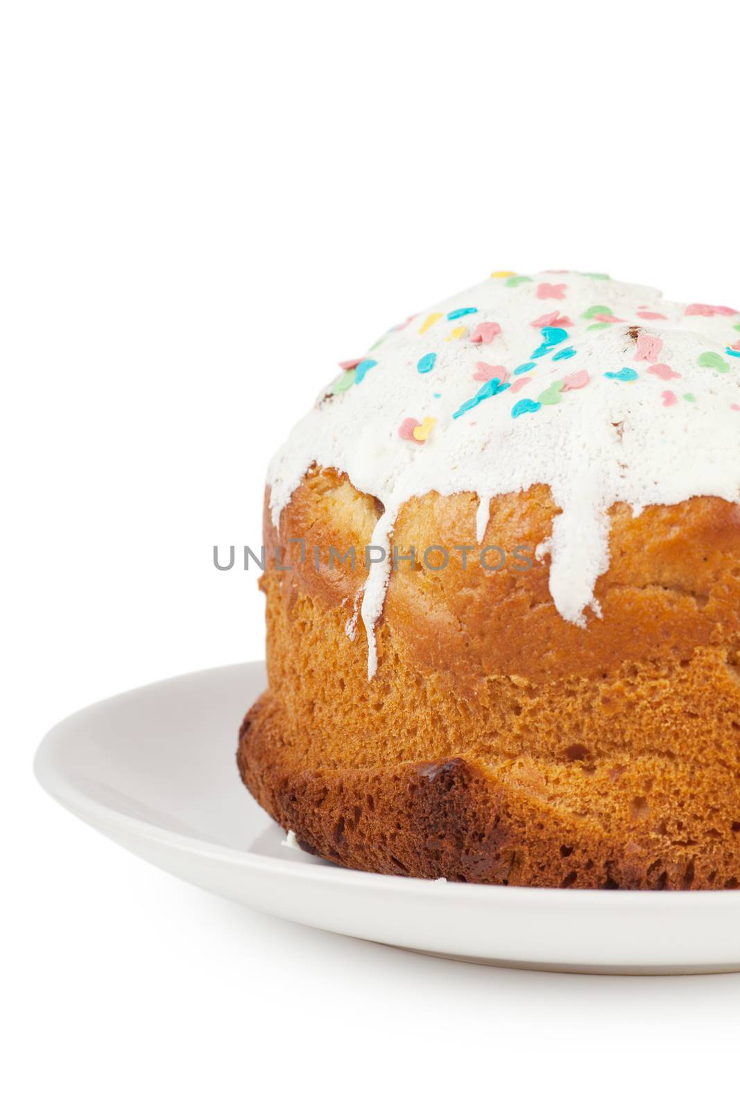 Closeup view of cake with icing on a plate over white background