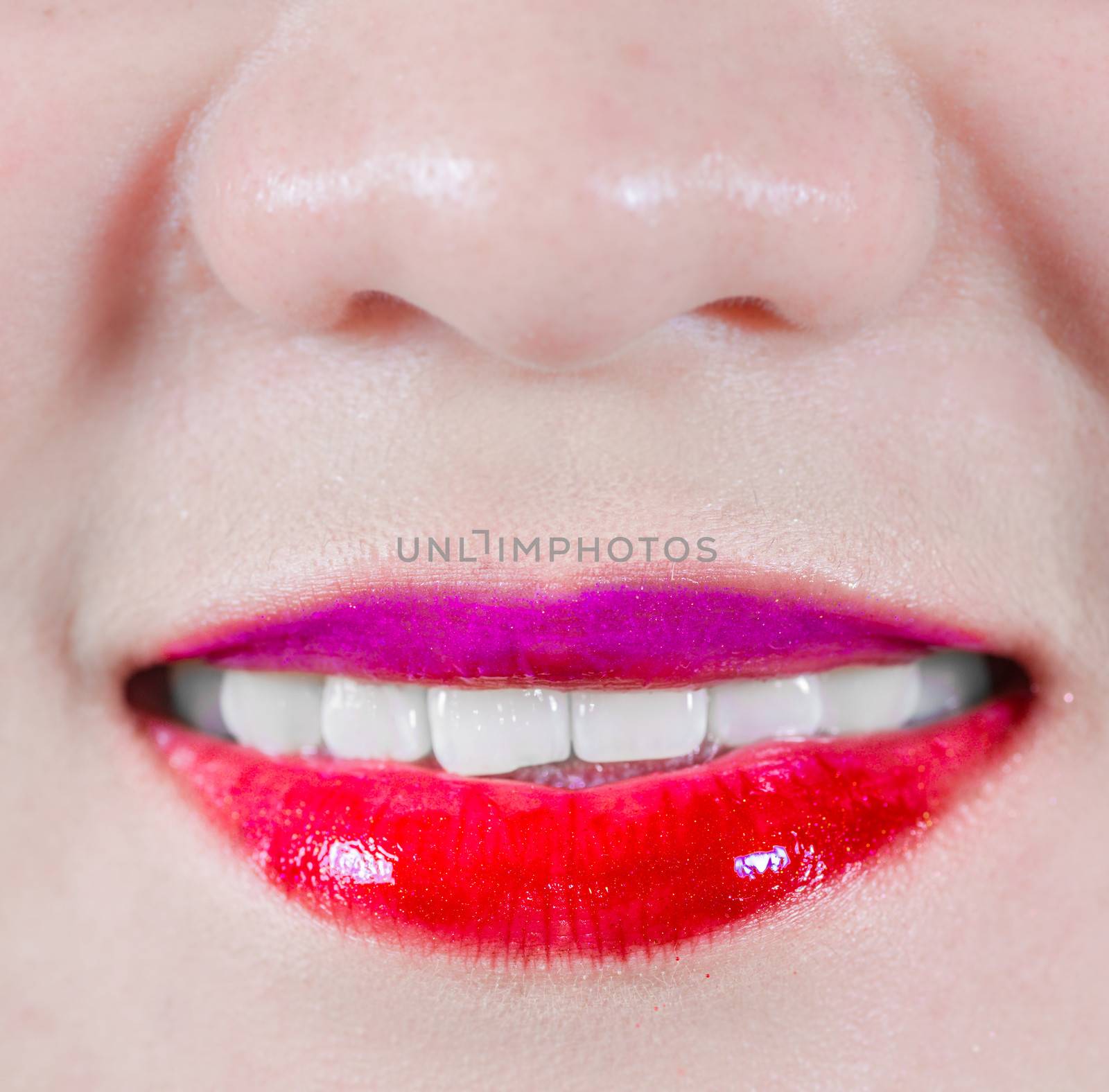 Woman lips with makeup smiling by IVYPHOTOS