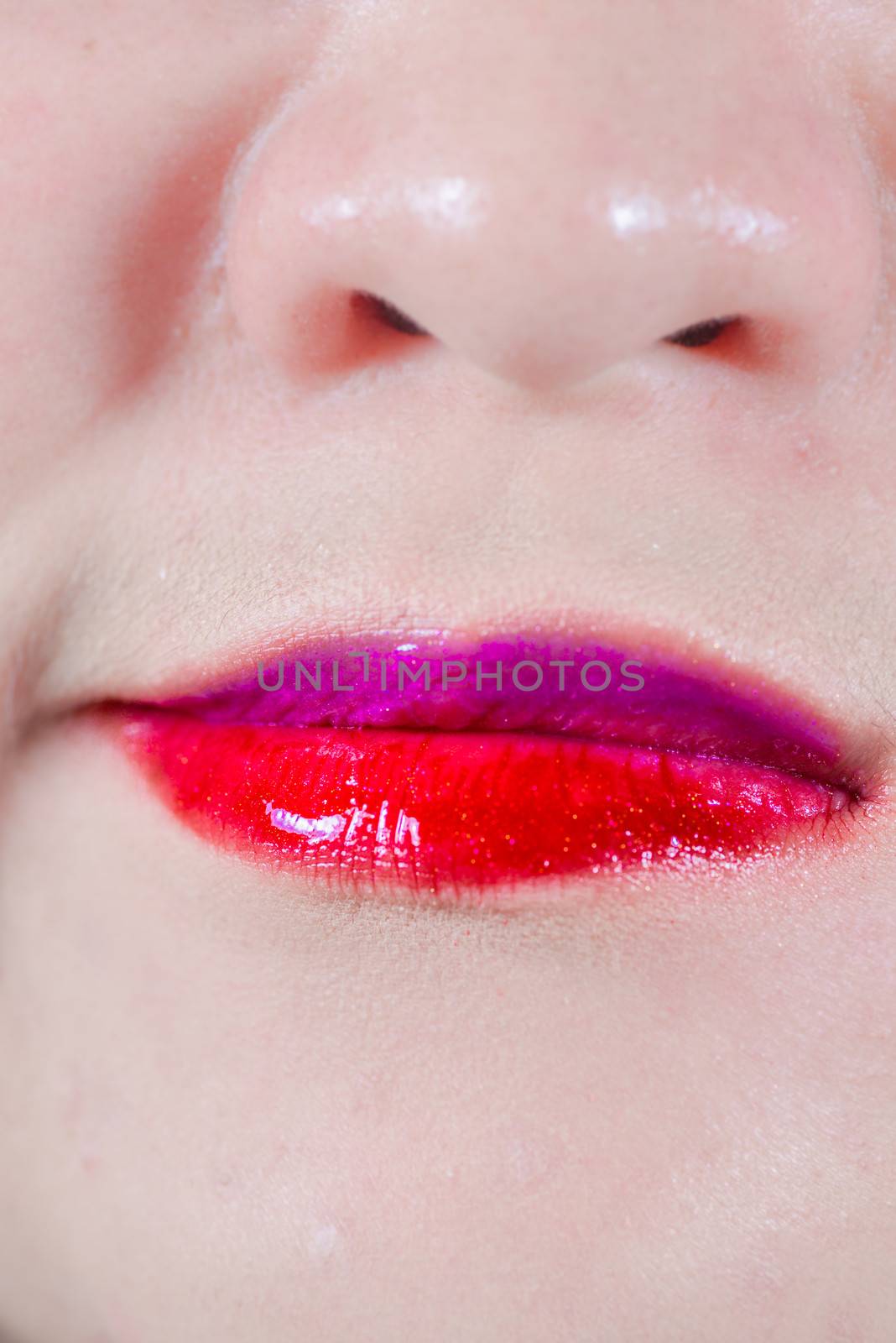 Woman lips with makeup and smirk by IVYPHOTOS