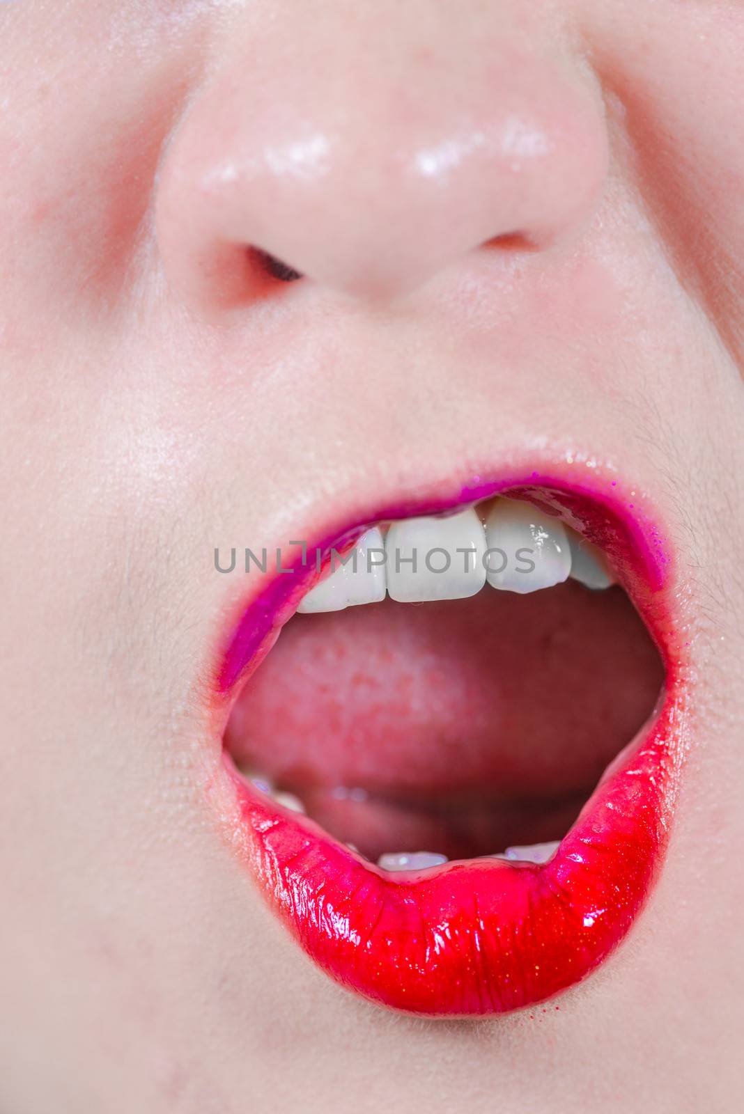 Woman lips with makeup yelling by IVYPHOTOS