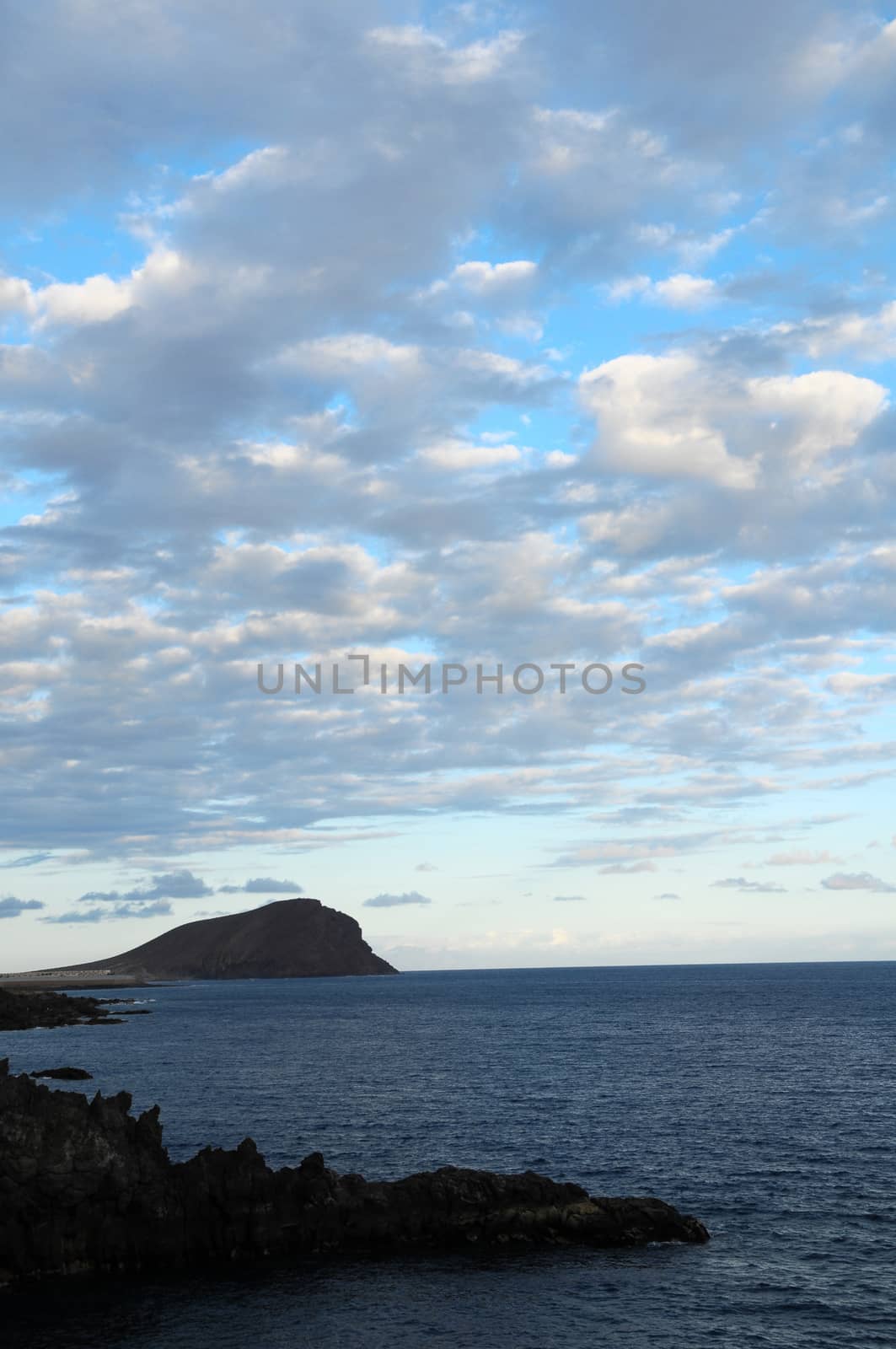 Some Colored Clouds over the Ocean on a Blue Sky