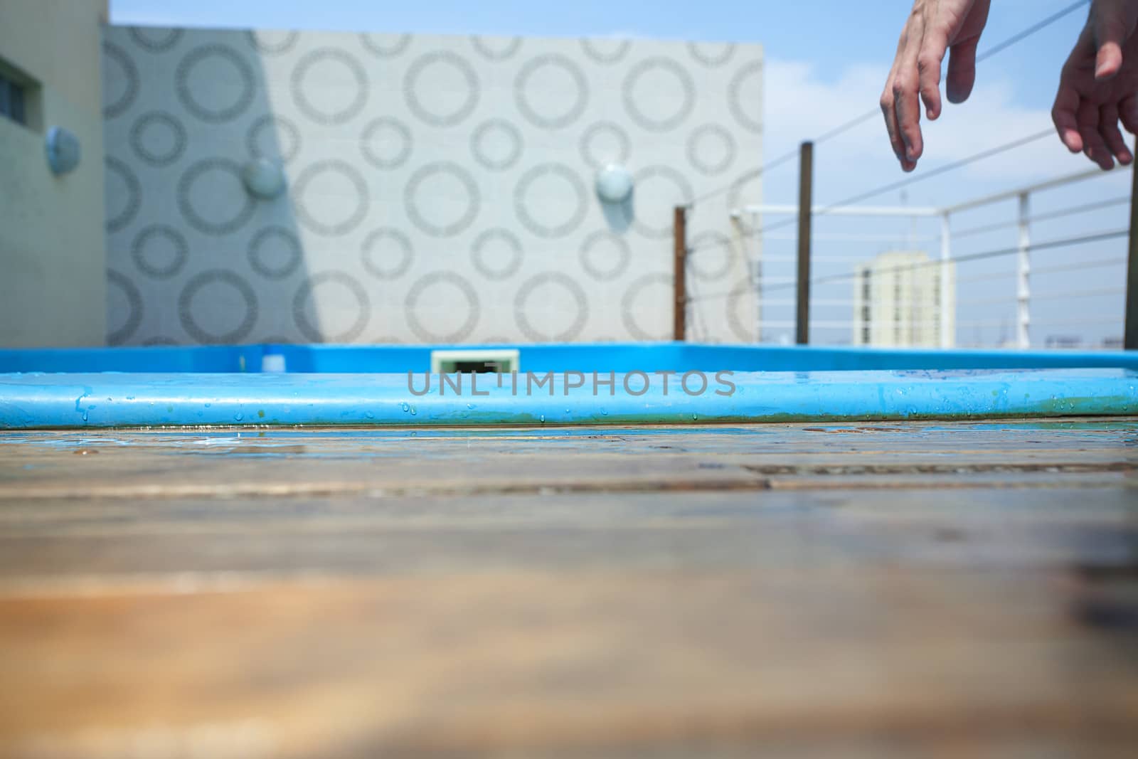 man's hands on the background of the pool