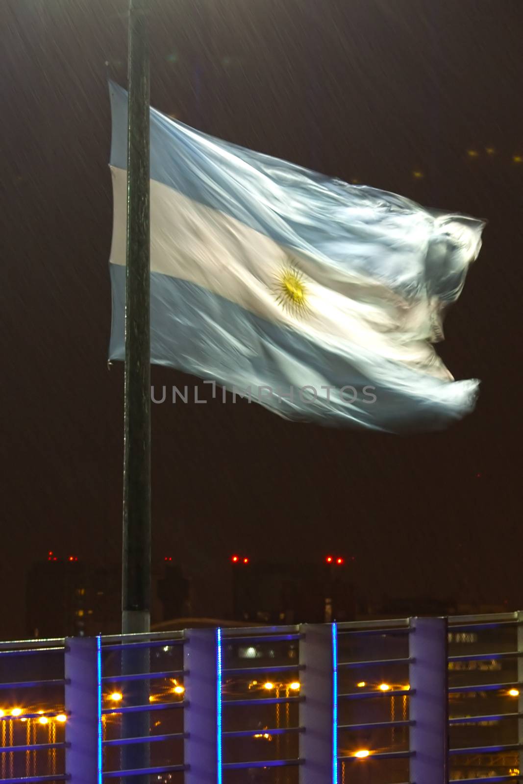night view of buenos aires in the rain and the Argentine flag by jannyjus