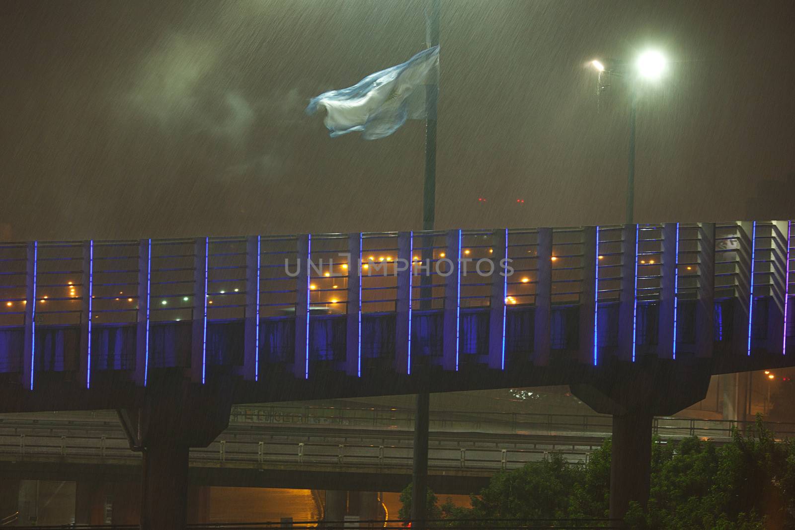 night view of buenos aires in the rain and the Argentine flag by jannyjus