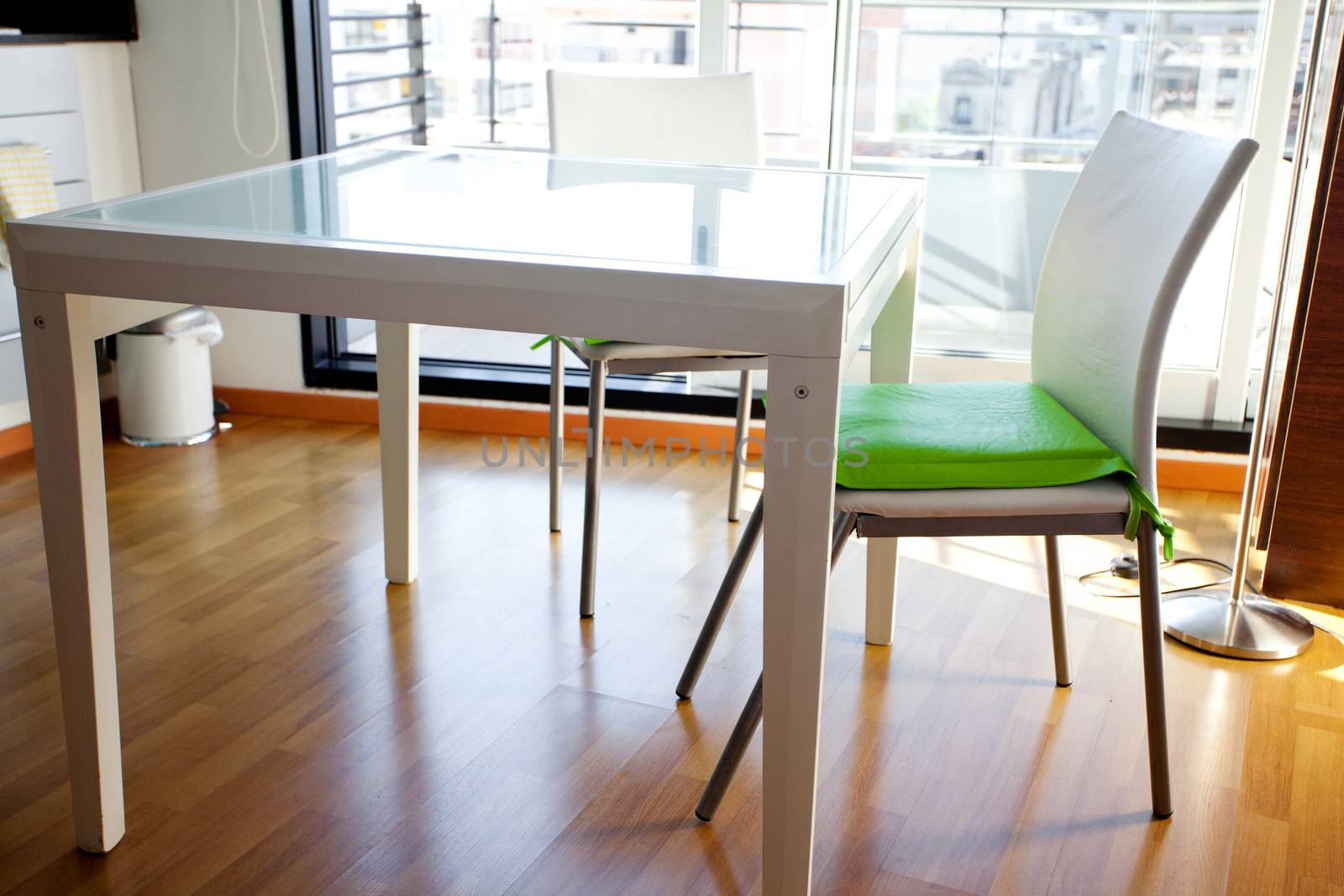 table and chairs in front of windows in the room