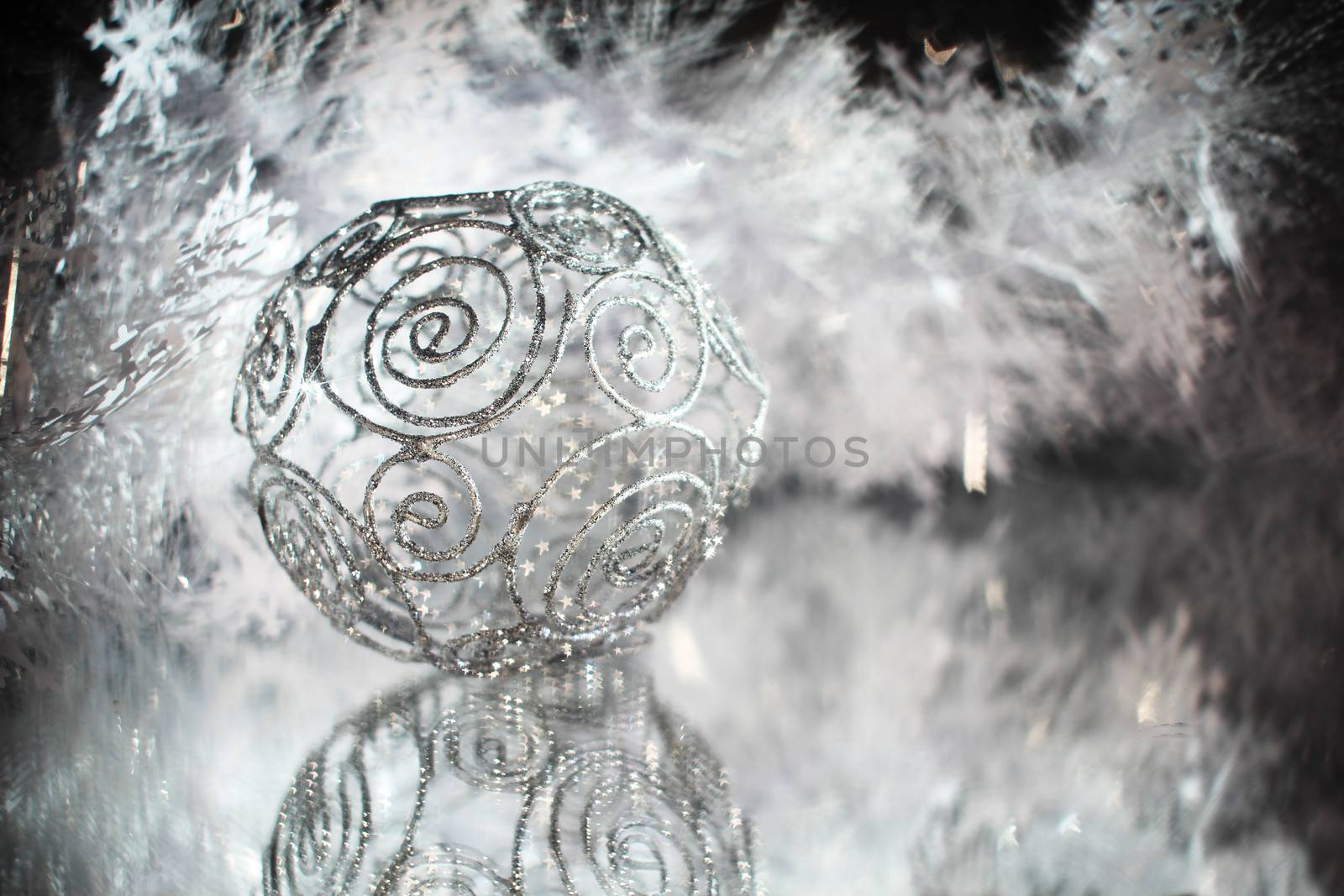 Silver christmas ball with shiny decorationand stars