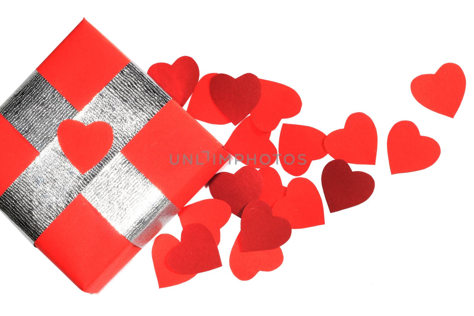 Valentines Day gift in red box and small hearts isolated on white top view