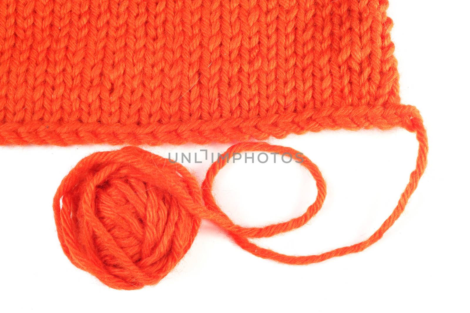 Wool yarn and knitted textile isolated on white background