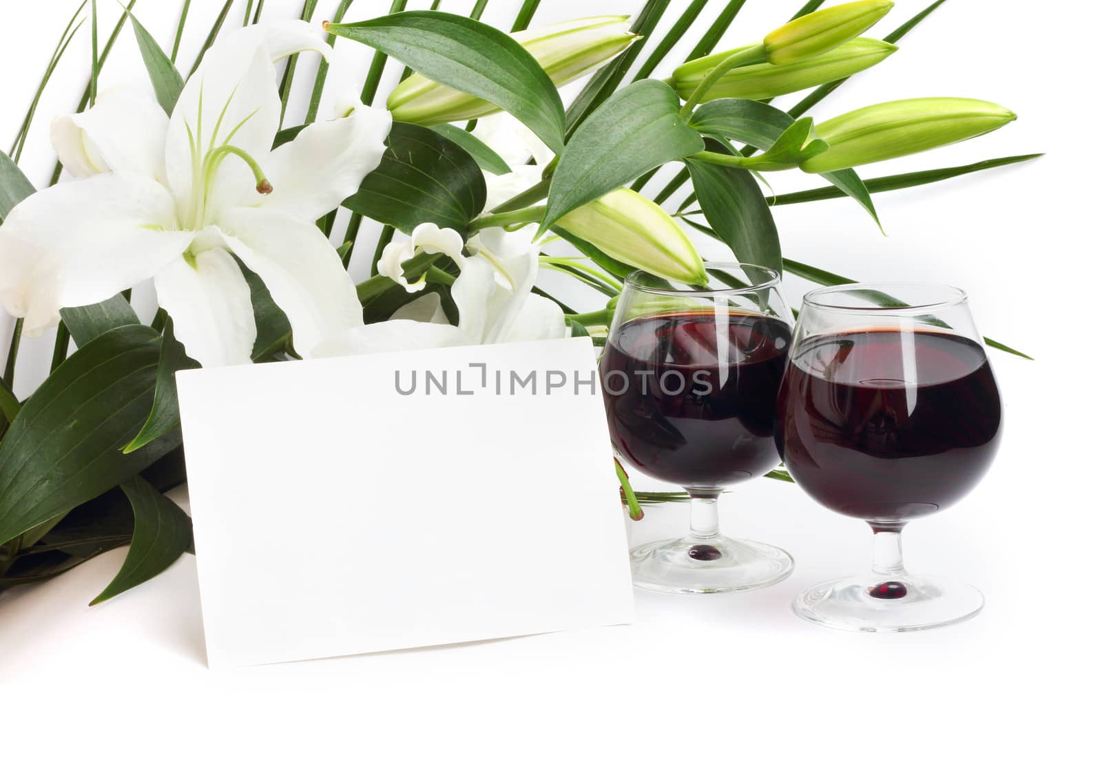 Wine and flowers on white background