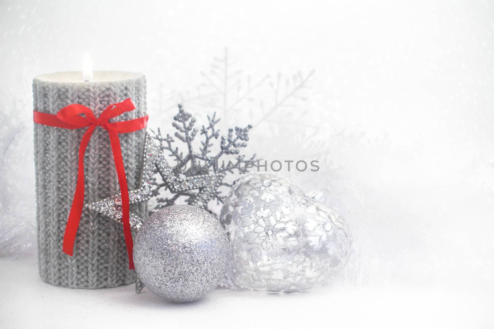 Christmas card with burning candle and decoration on white