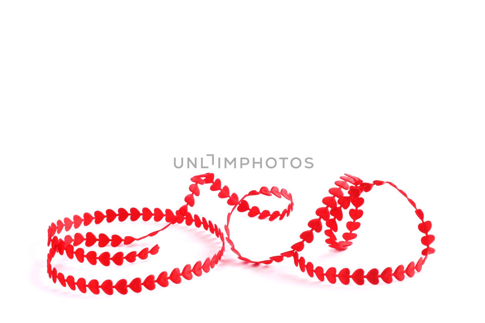 Red ribbon made of hearts isolated on white background