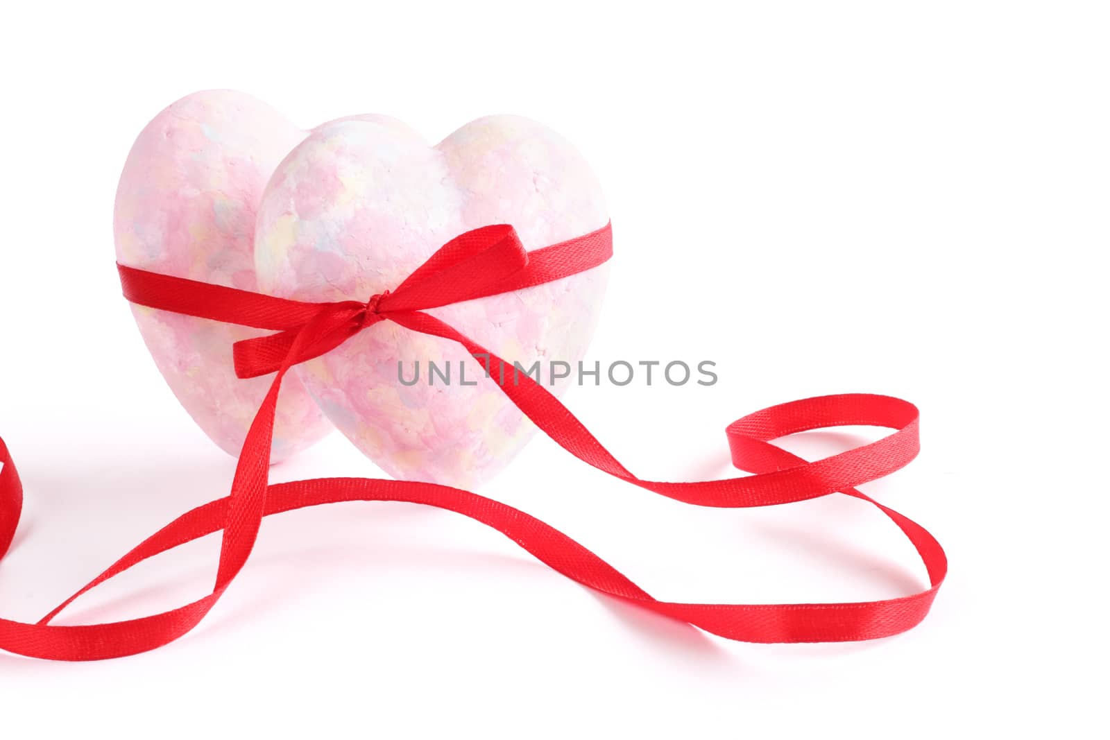 Two hearts tied with ribbon isolated on white background