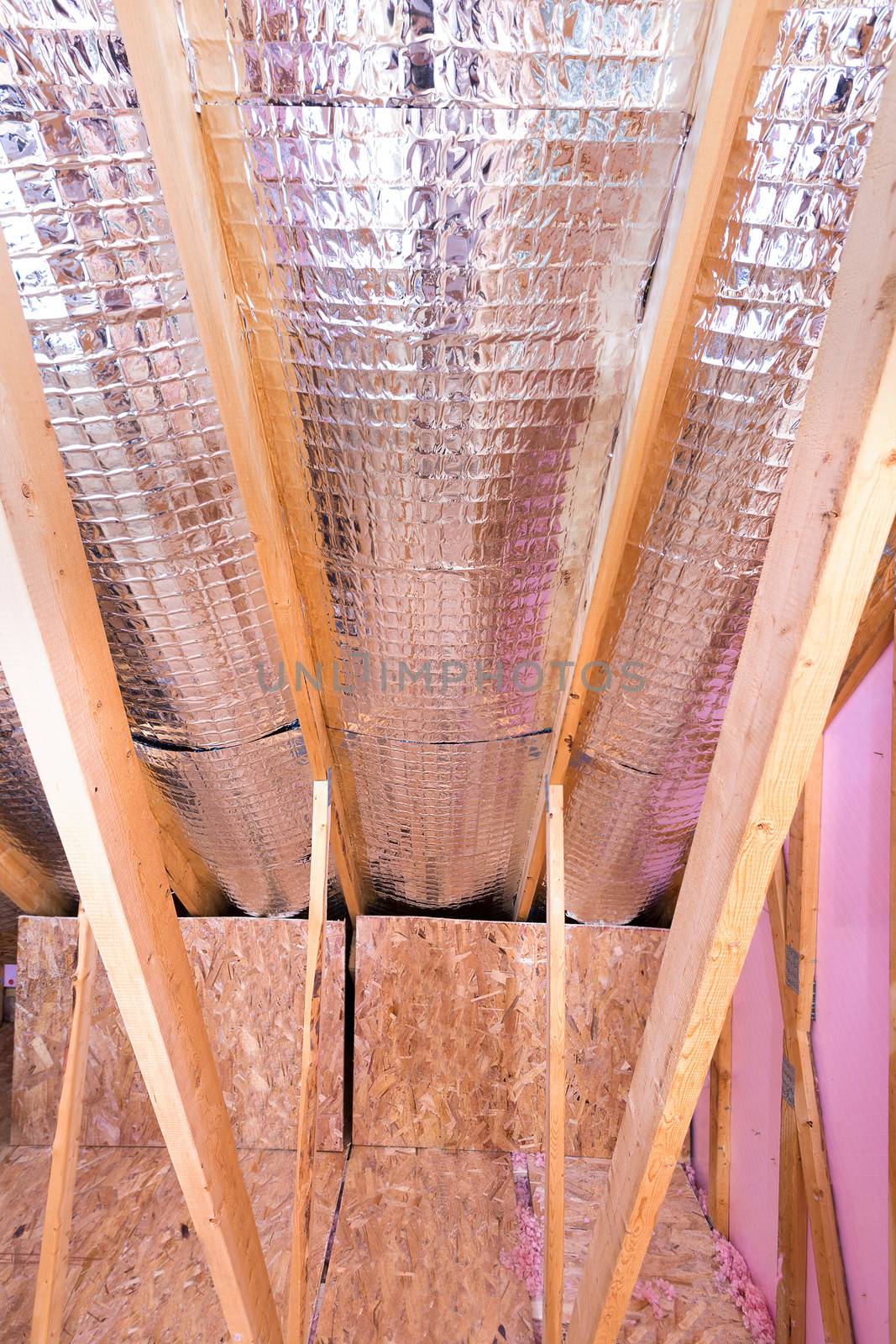 Continuous work of insulating of attic with reflective heat barrier between the attic joists and knee wall