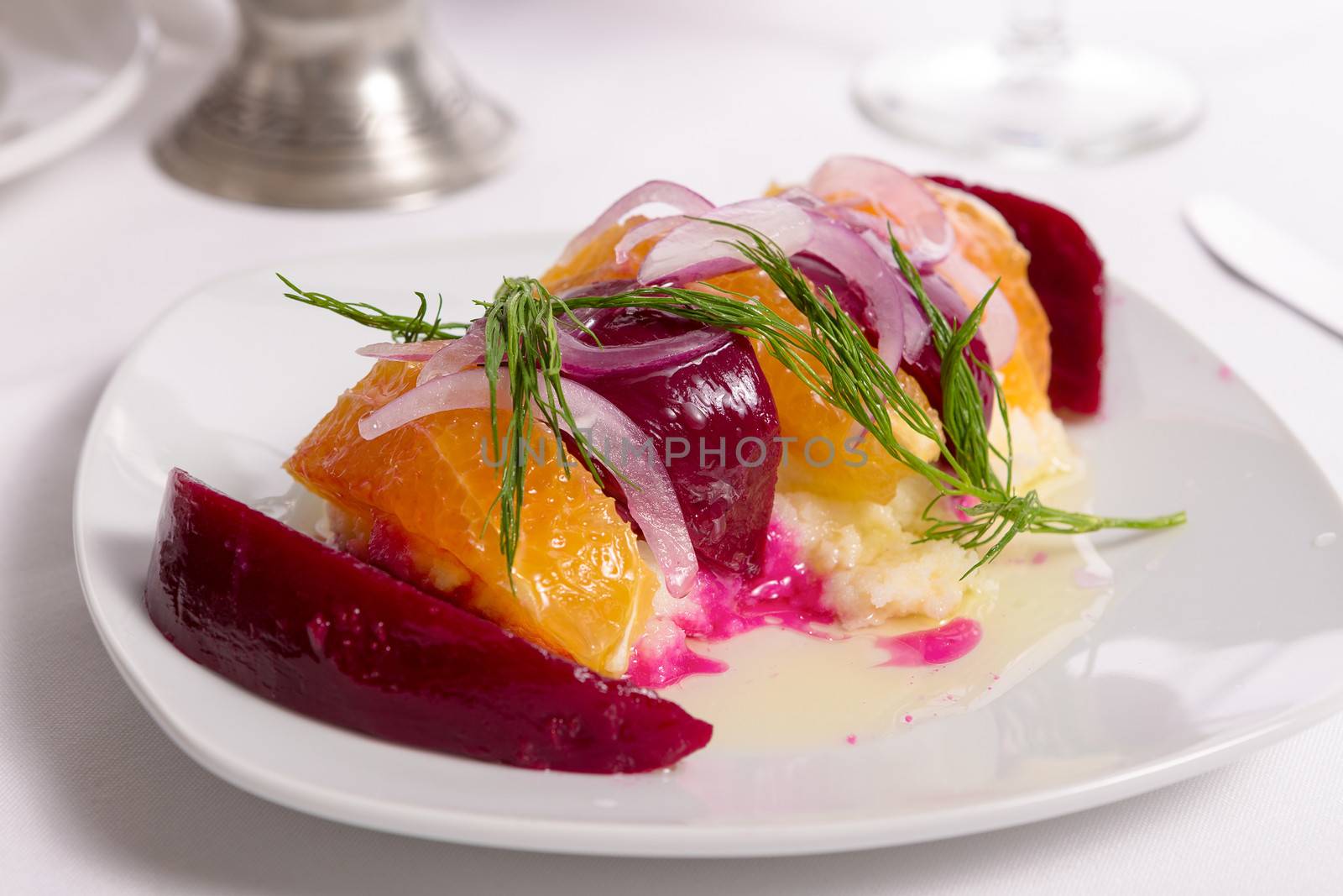 Strained yogurt labneh citrus salad with pickled beets and peeled oranges garnished with onions and dill served with oil