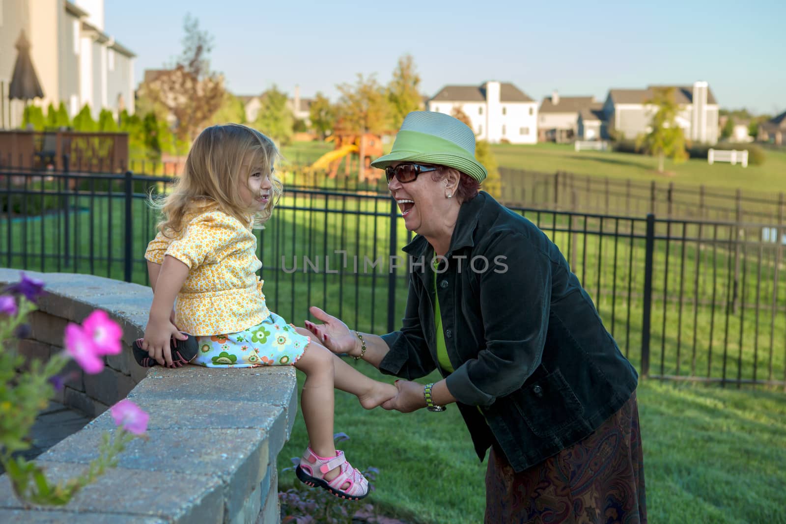 Frolicsome Toddler Girl Hiding Her Shoes from her Grandmother by coskun