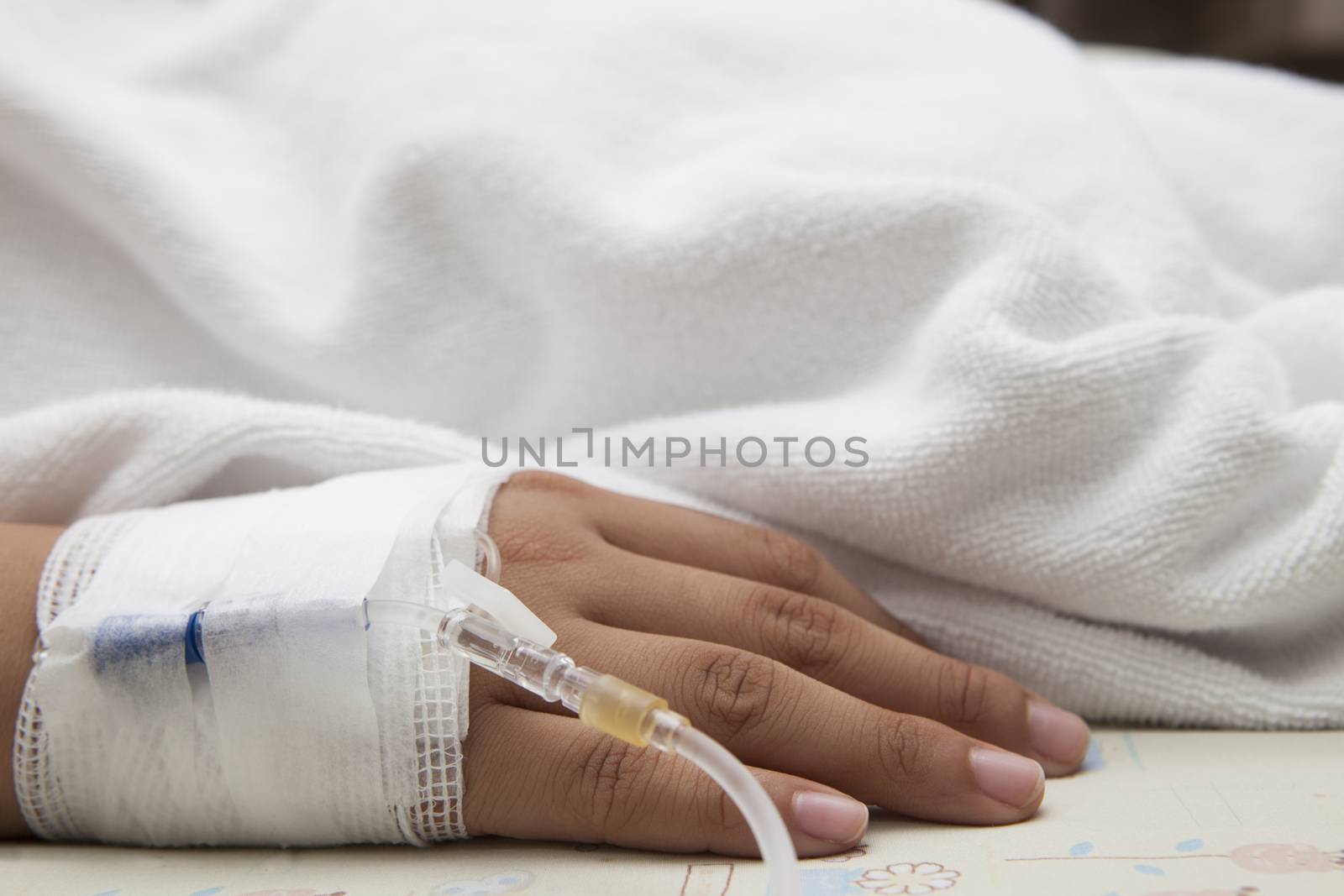 hand of patient on hospital bed