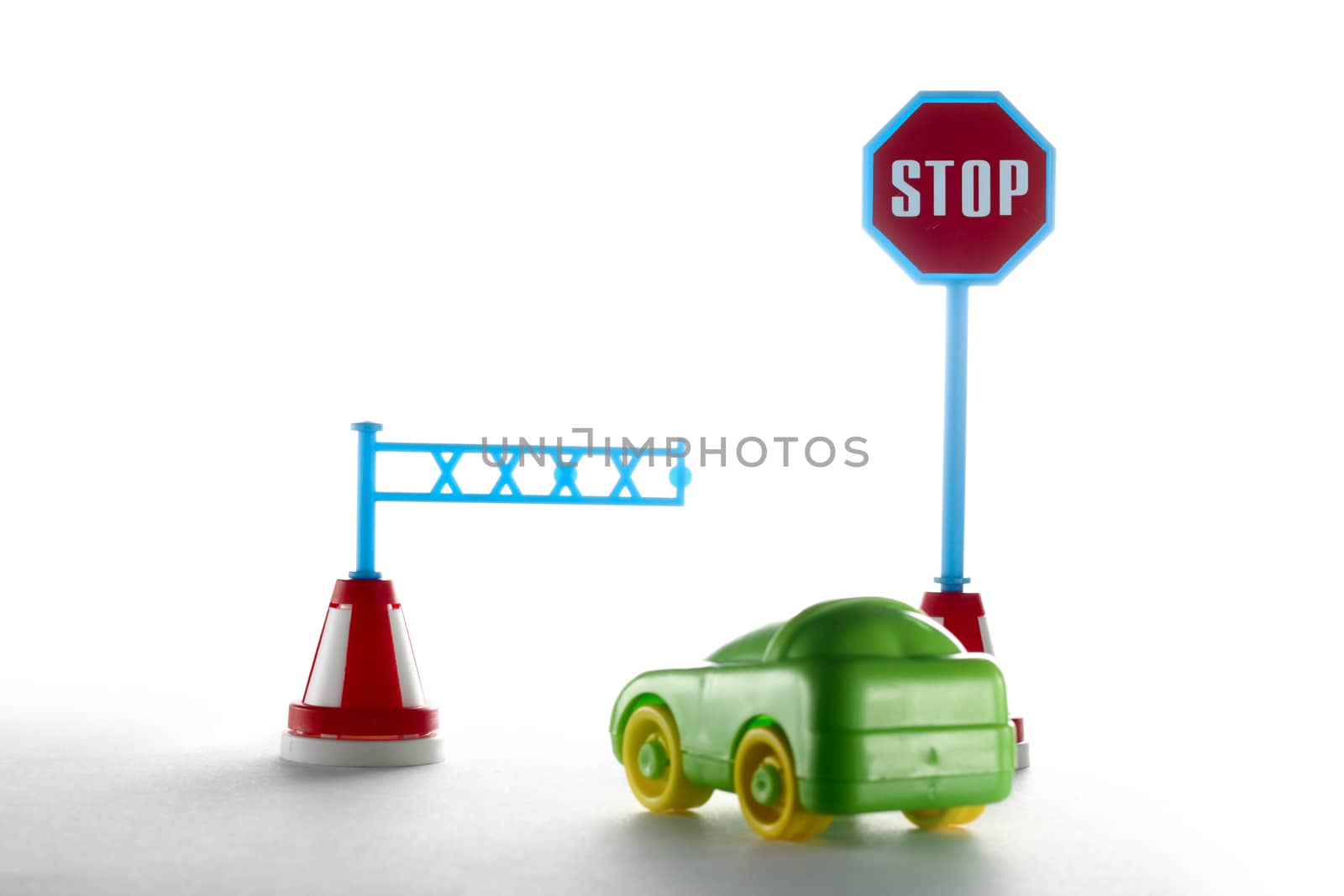 Car behind barrier with sign on white background