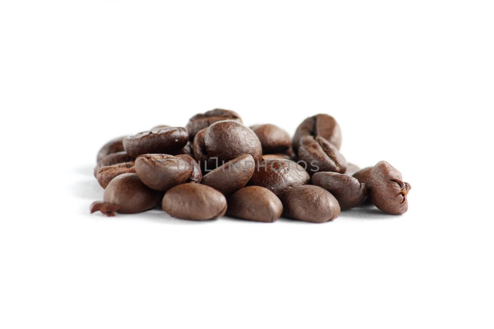 A lot of roasted coffee beans at dark background