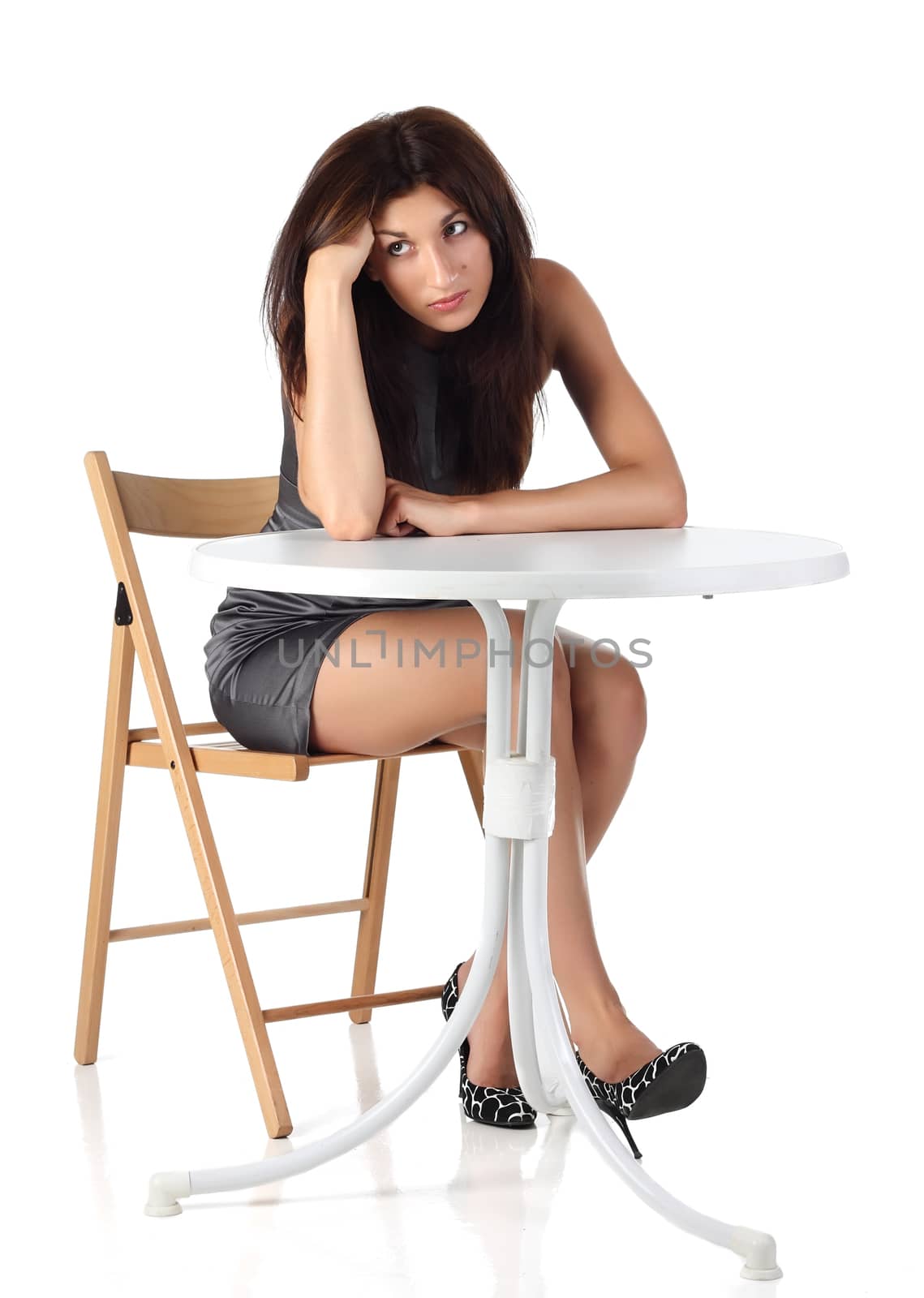 Girl sitting on a chair near the table