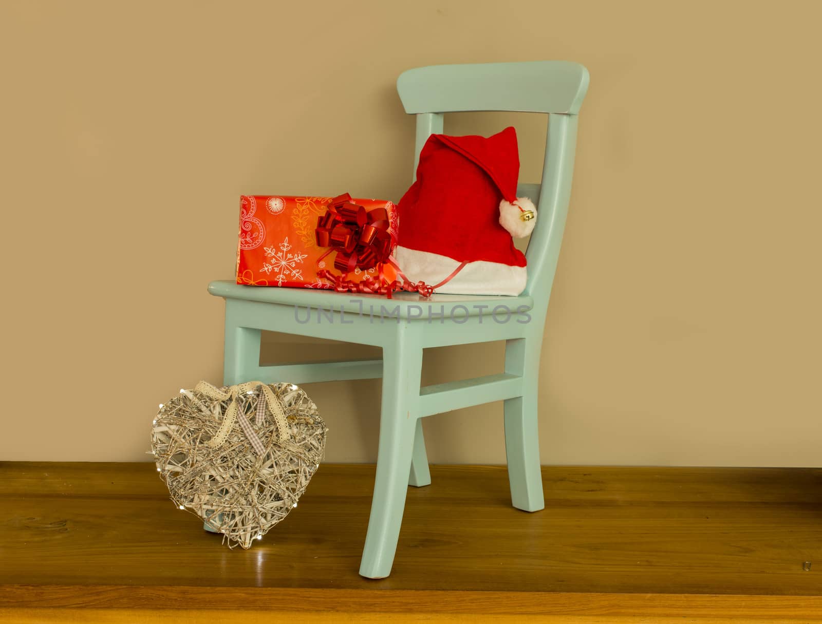 santa claus hat on chair with presents and balls for christmas