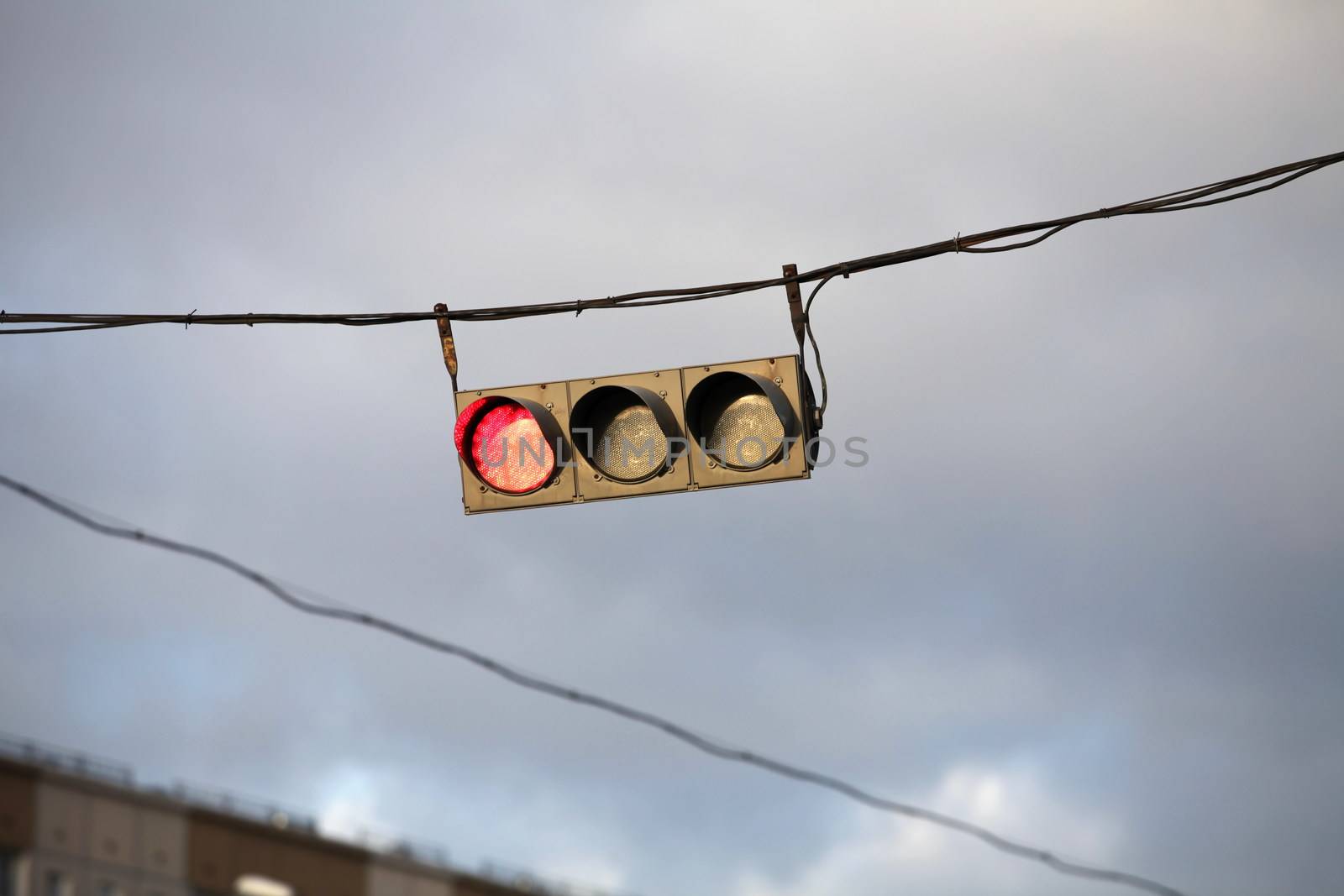 Traffic light on the background of the storm sky