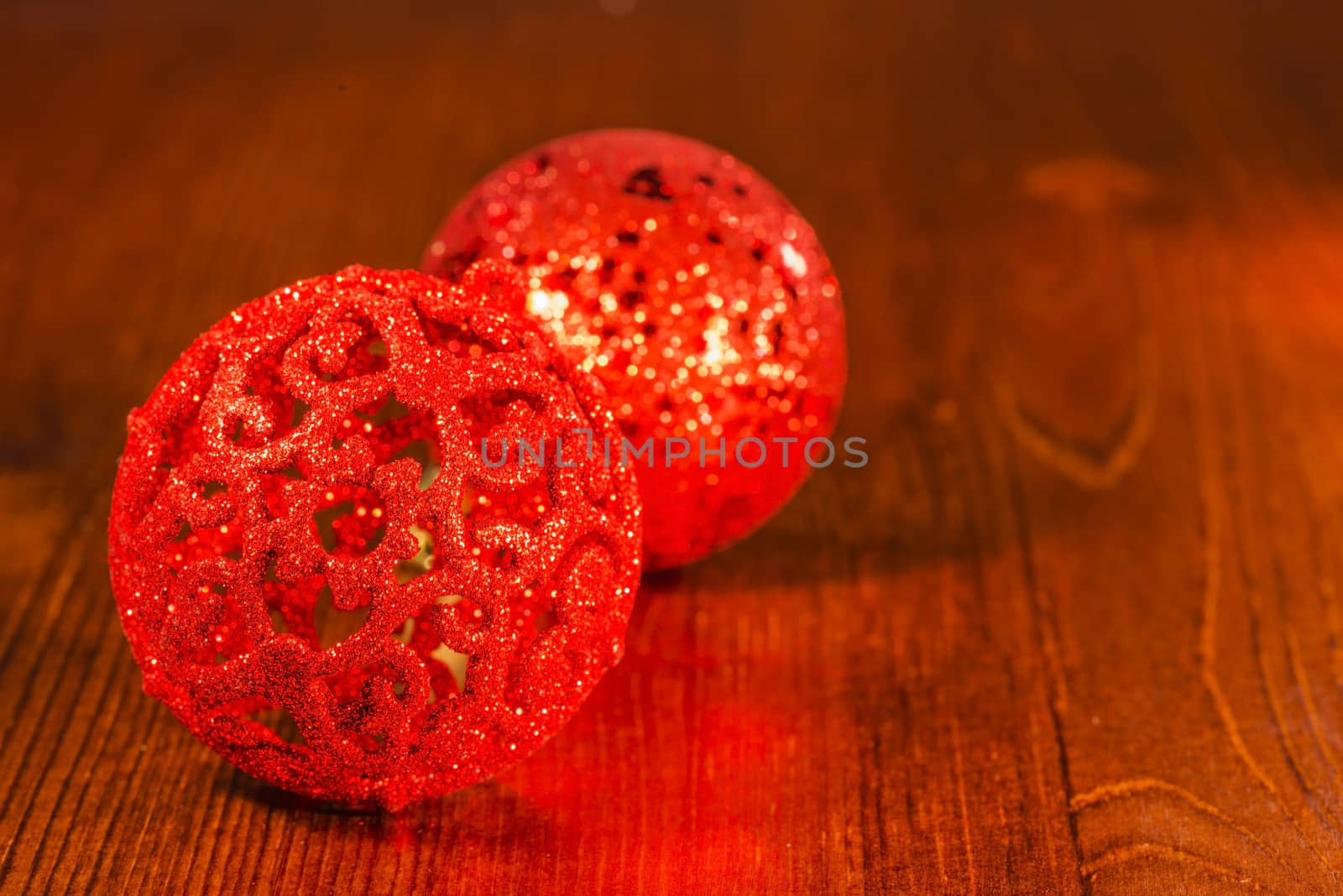 Red Christmas ornaments on wooden base