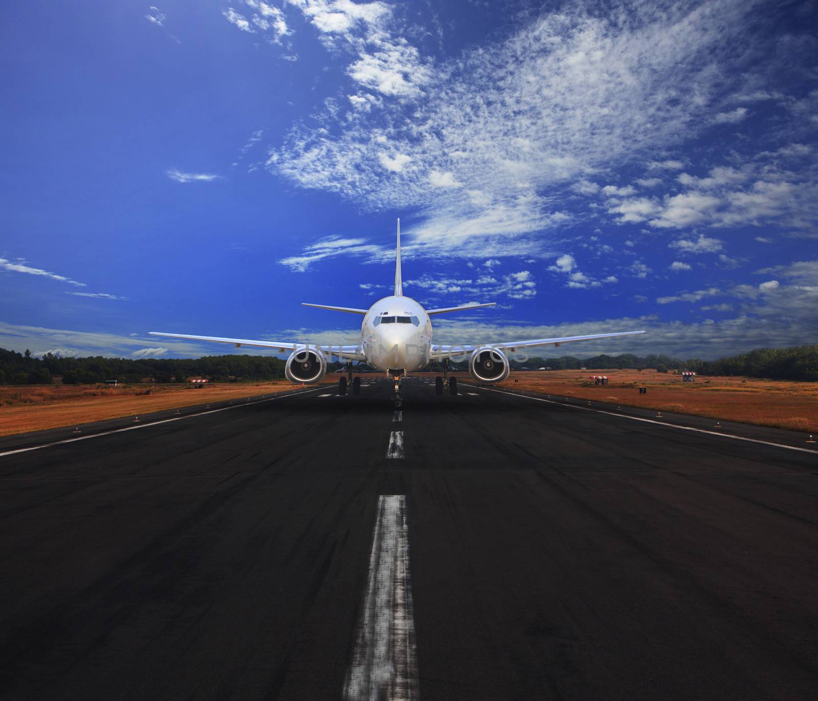 passenger air plane running on airport runway with beautiful blue sky with white cloud use for transport and traveling journey background by khunaspix
