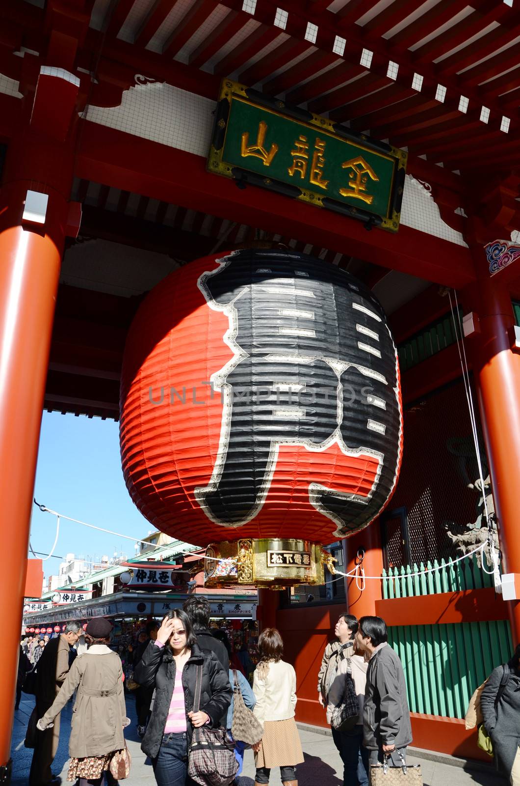 TOKYO, JAPAN - NOV 21: Imposing Buddhist structure features a massive paper lantern painted in vivid red-and-black tones to suggest thunder clouds and lightning at sensoji temple on November 21, 2013 in Tokyo, Japan.