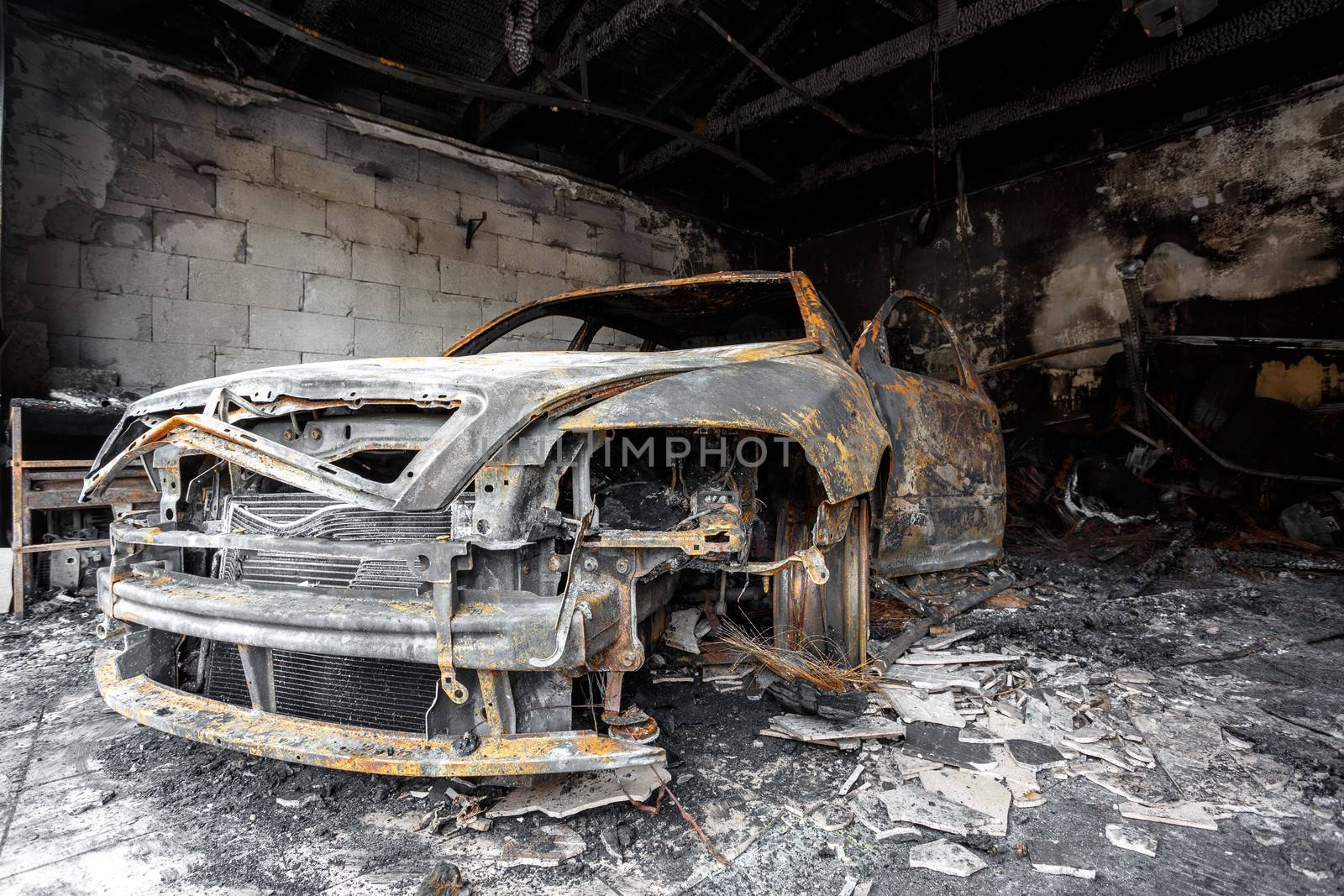 Close up photo of a burned out car in garage after fire for grunge use