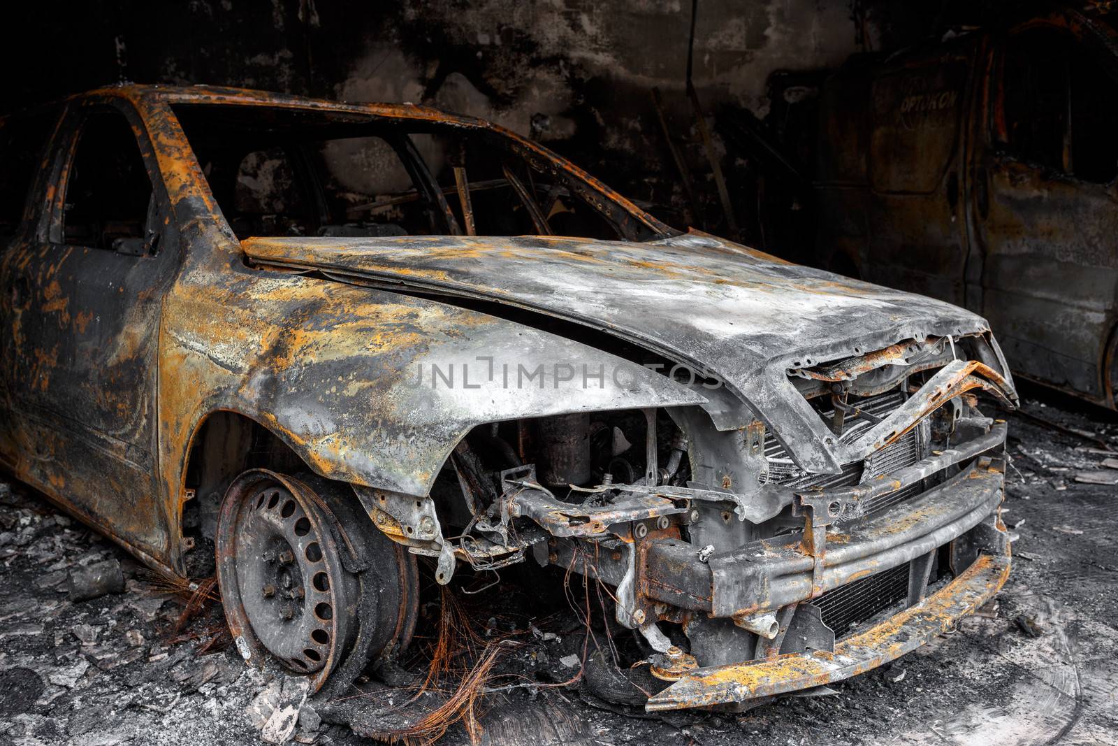 Close up photo of a burned out car in garage after fire for grunge use