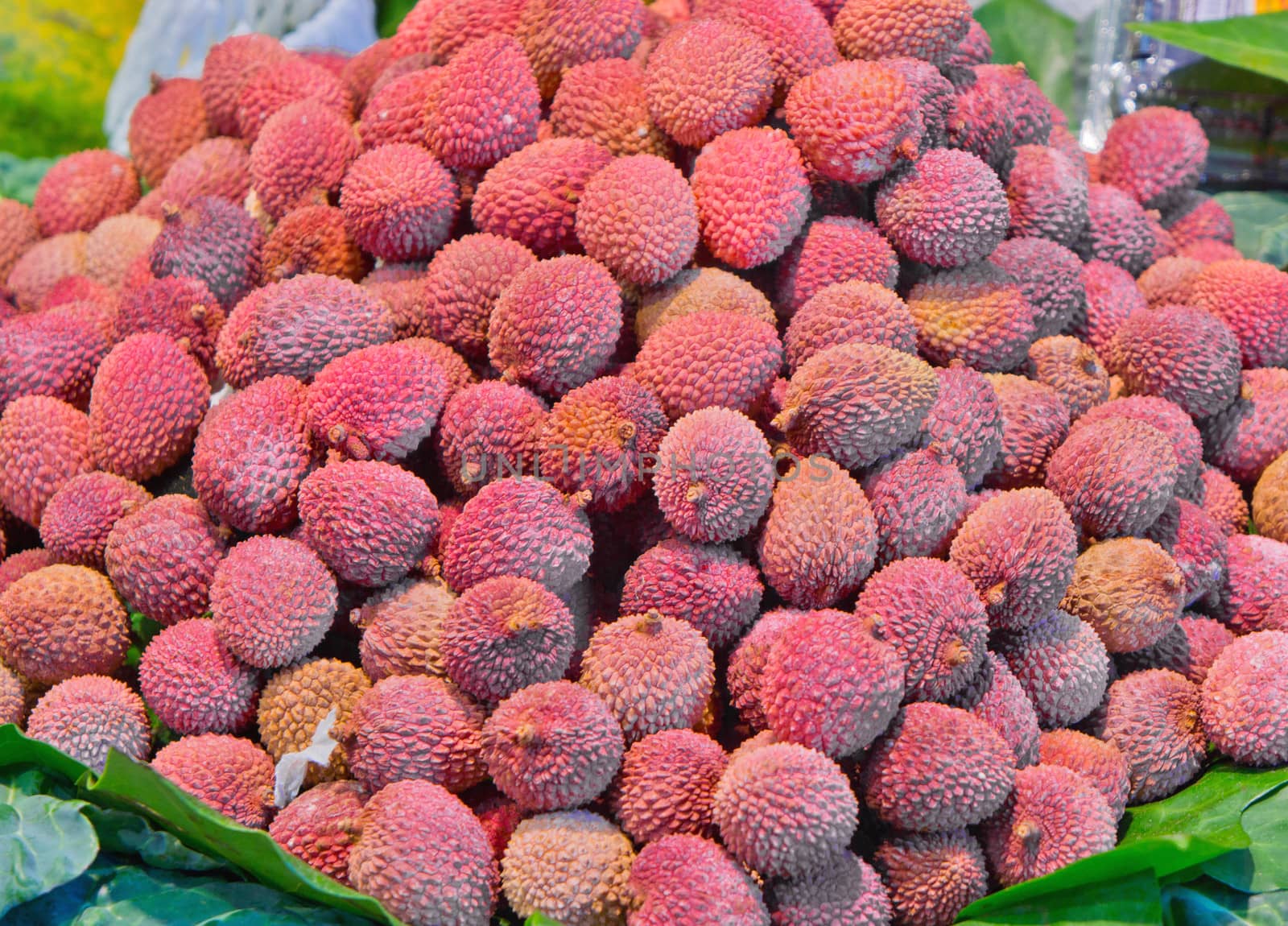 A bunch of fresh lychees on a market stall