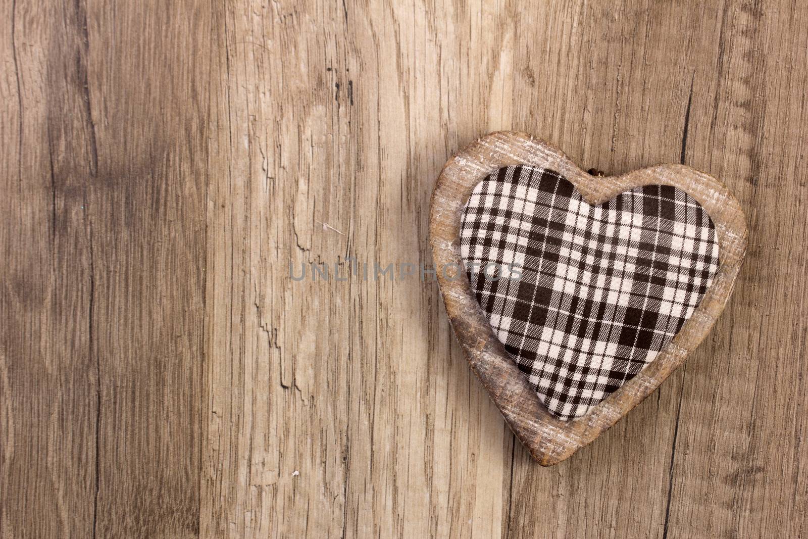 heart as symbol for christmas with wooden background
