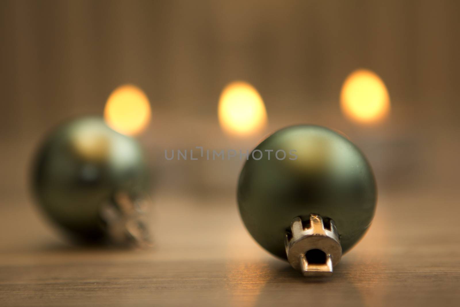 christmas baubles green with wooden background and flames 