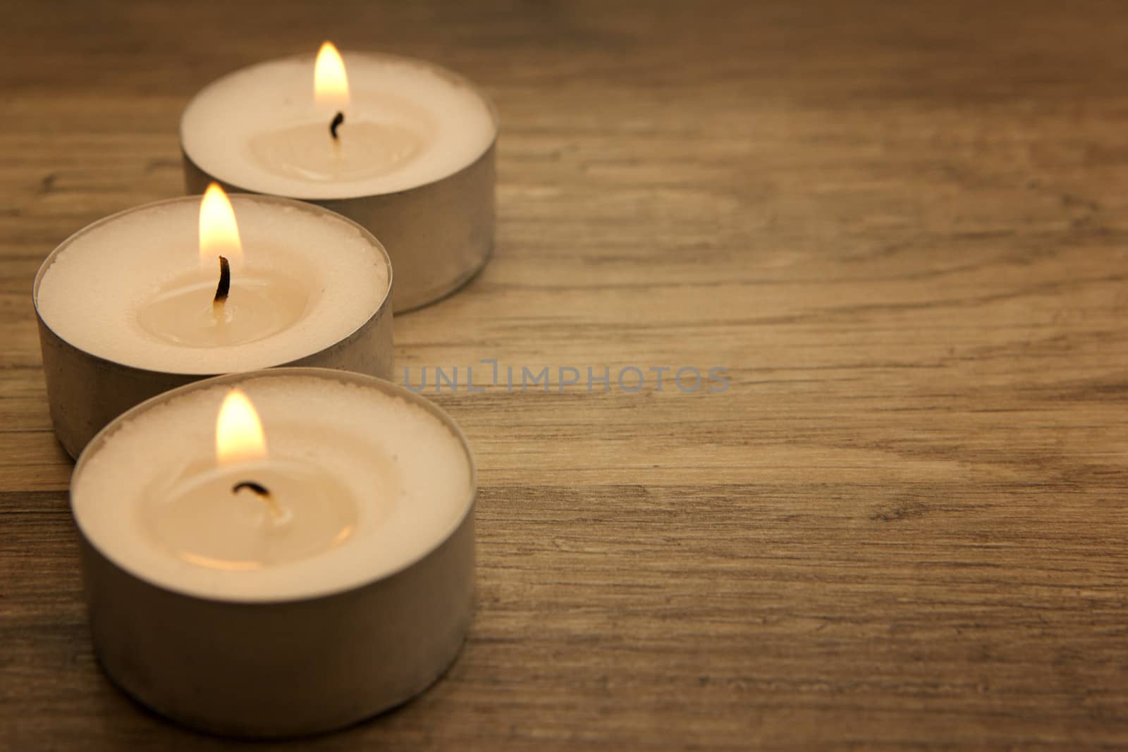 several tealights with wooden background