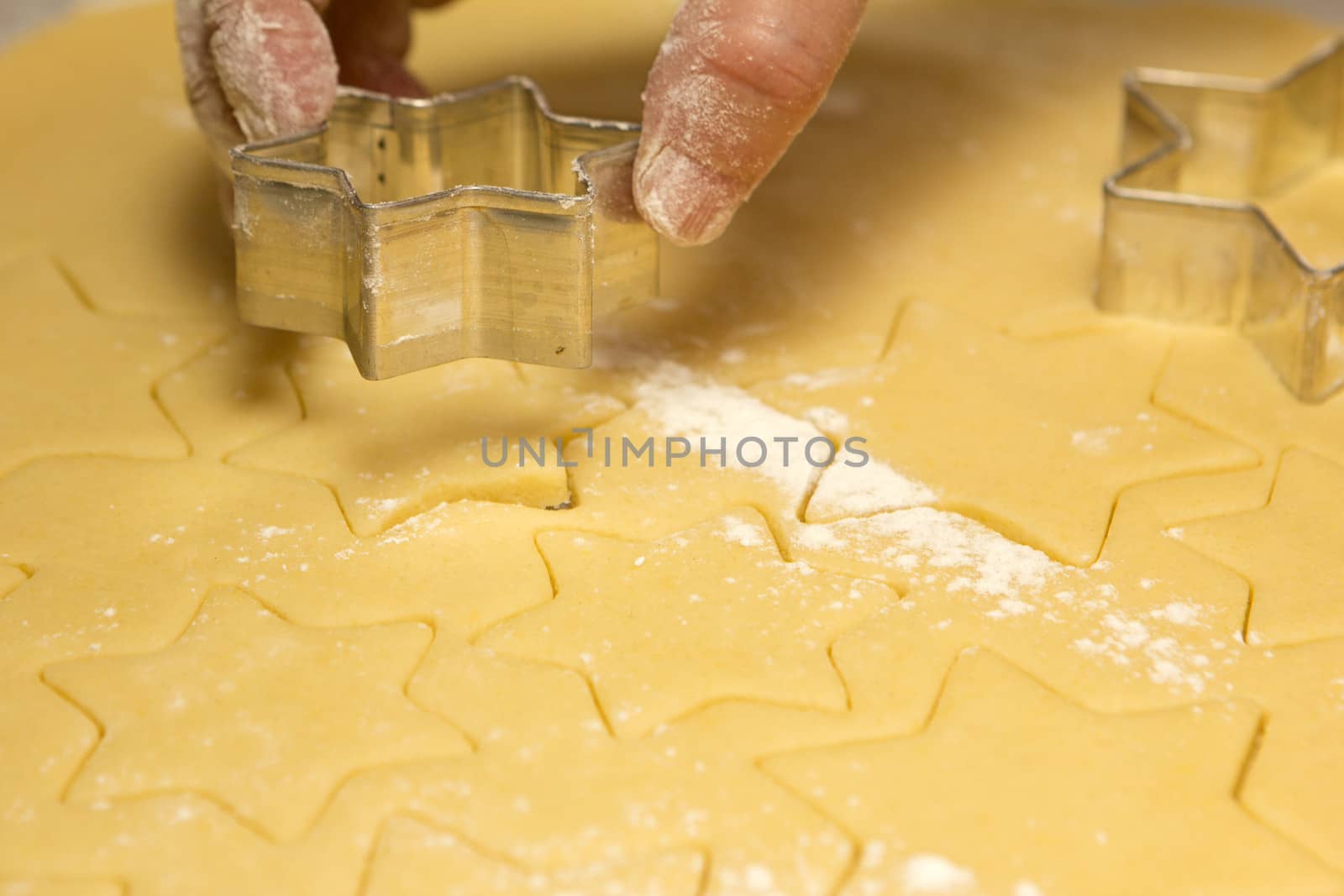 stars cut out the pastry with hand from woman