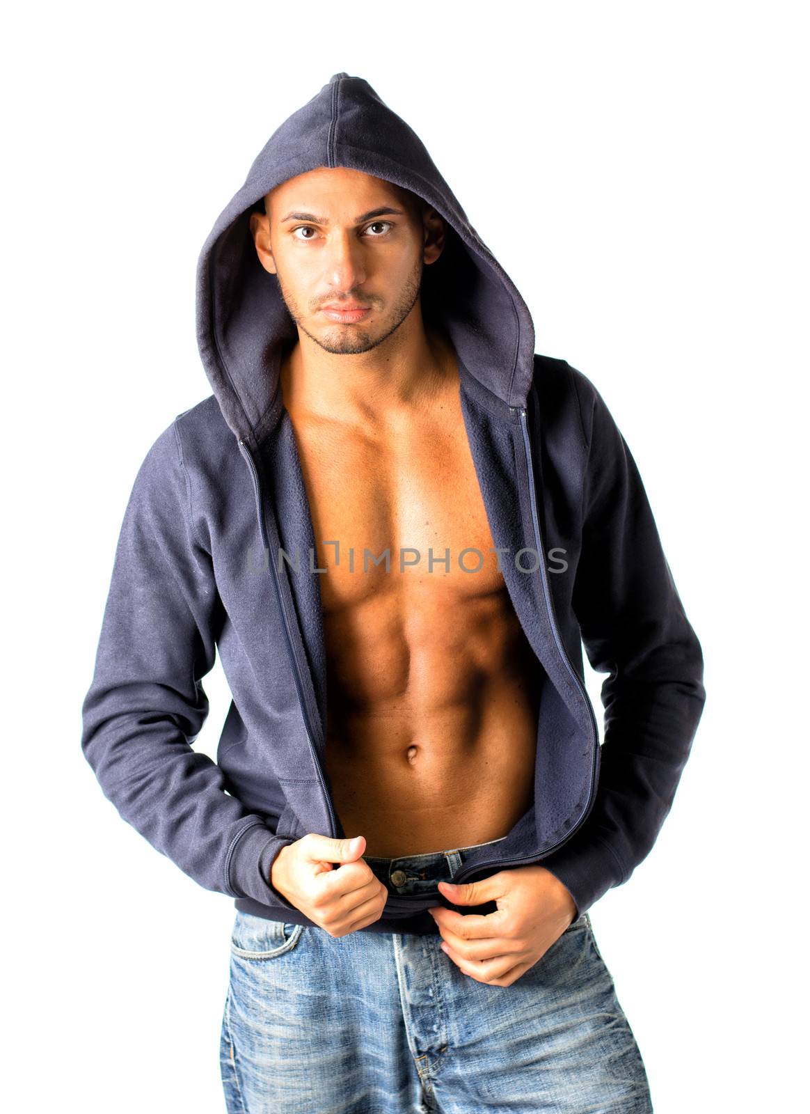 Young man with open blue hoodie and jeans bare chested, isolated on white