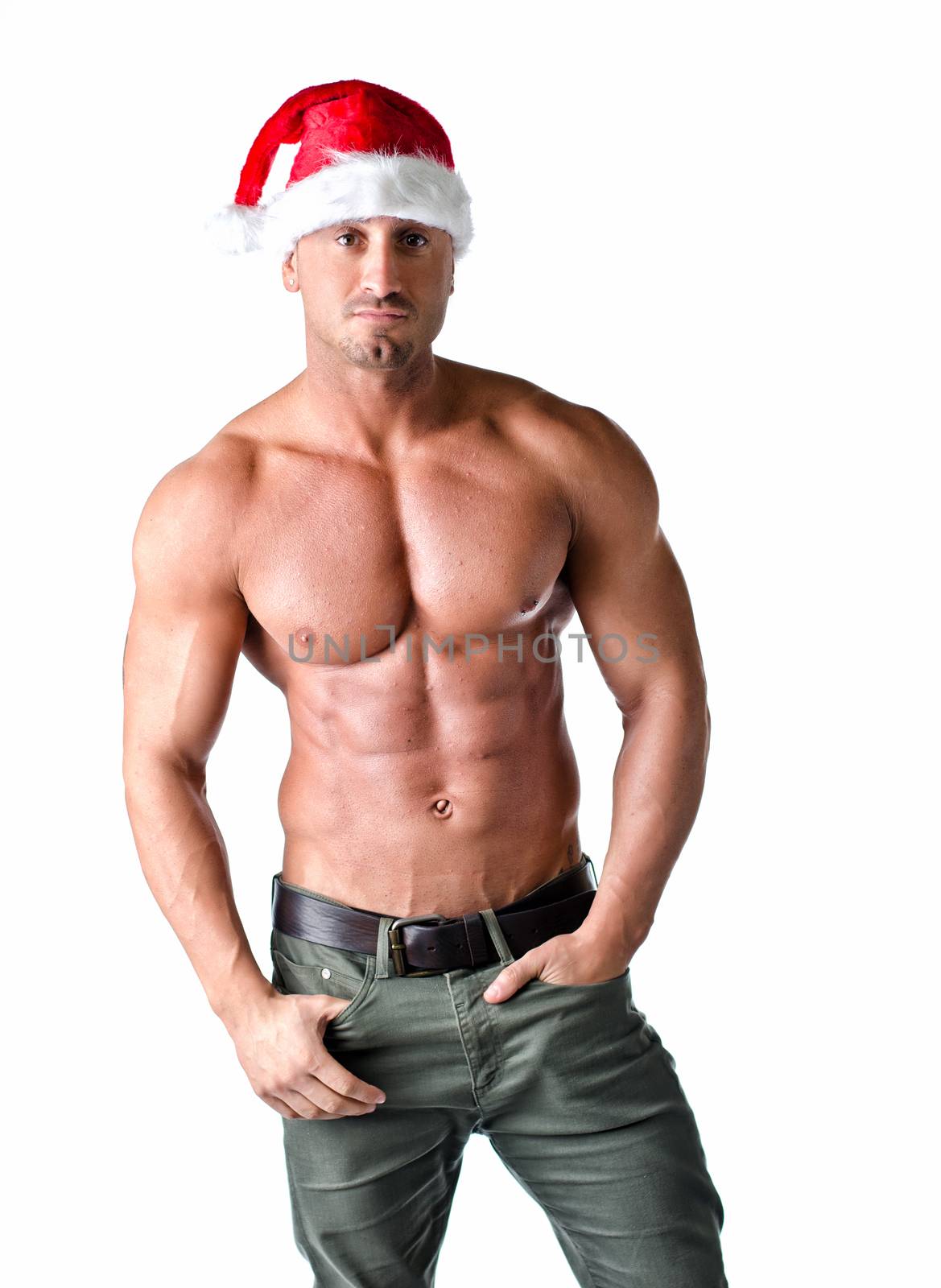 Christmas season: muscular bodybuilder shirtless wearing Santa Claus red hat, isolated on white