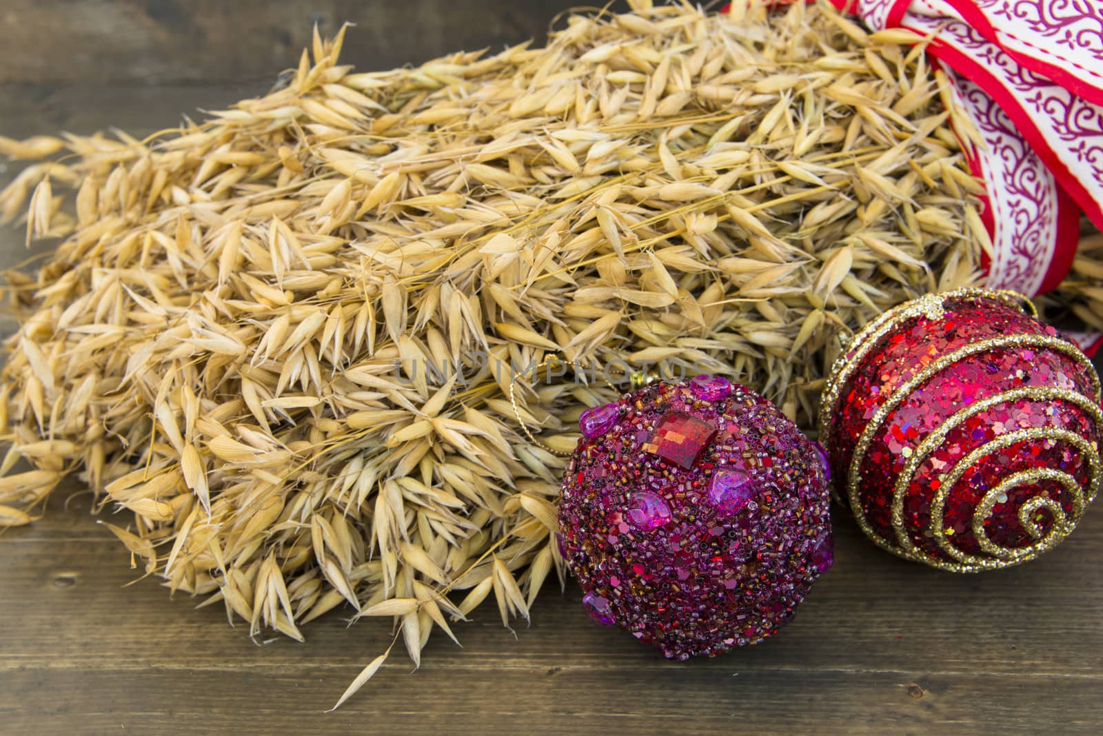 Two Christmas balls and a sheaf with ribbon