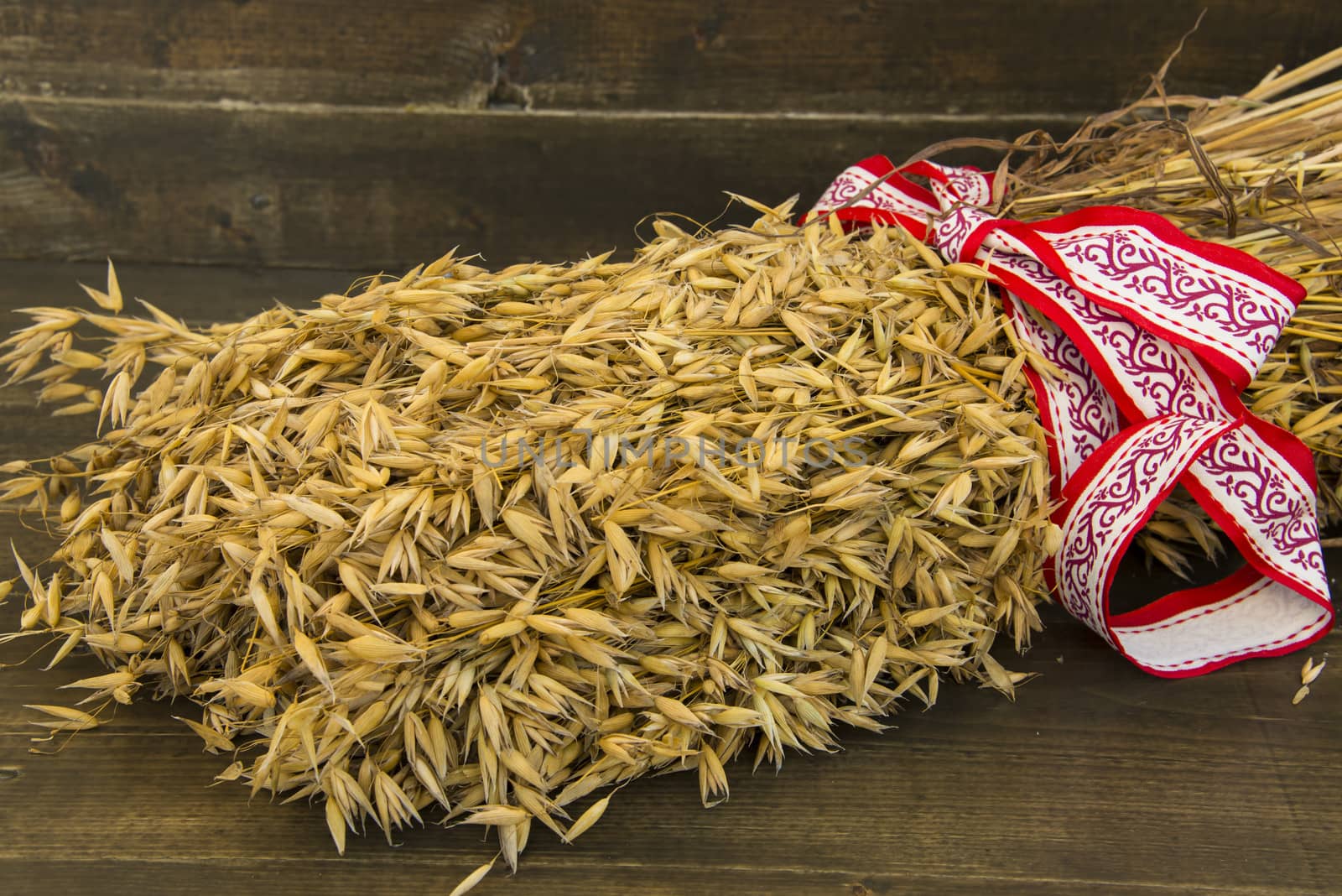 Sheaf of oats with a white and red ribbon and bow
