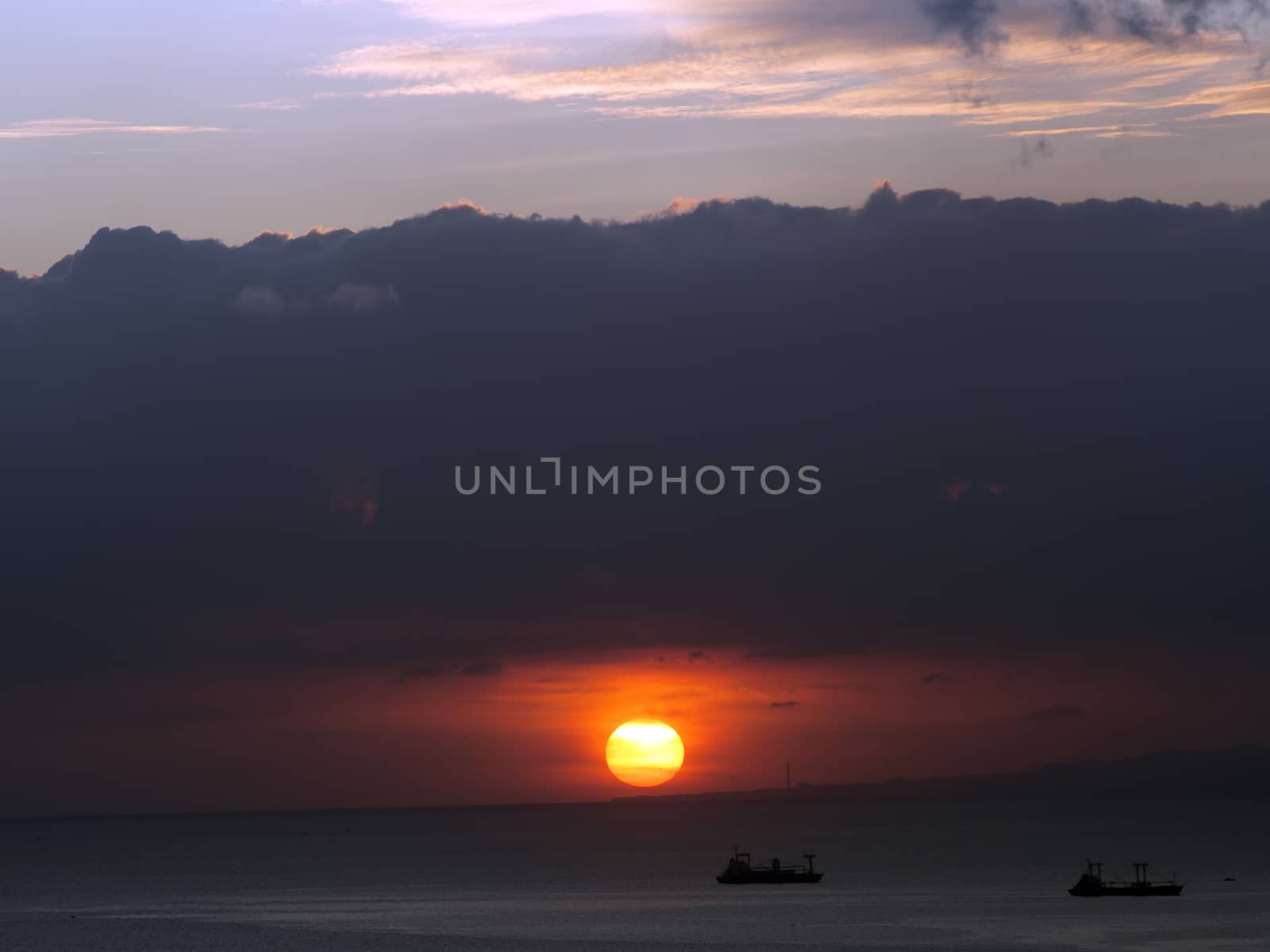 ships in the ocean at sunset