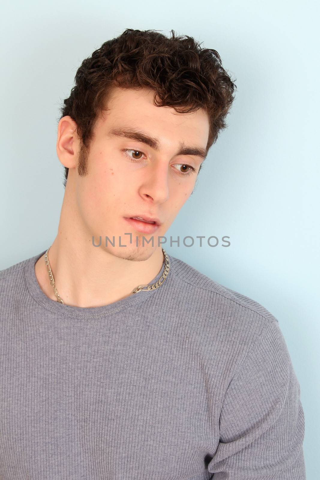 Attractive brunette male model in casual grey shirt
