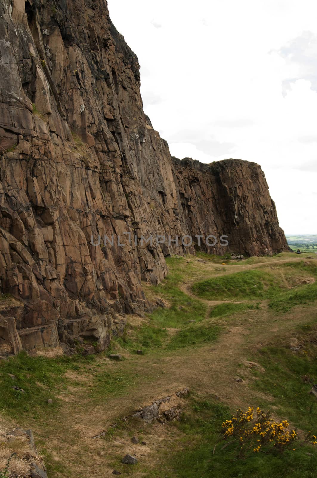 Arthur's Seat is the main peak of the group of hills which form most of Holyrood Park. It is situated in the centre of the city of Edinburgh, about a mile to the east of Edinburgh Castle. The hill rises above the city to a height of 250.5 m (822 ft), provides excellent panoramic views of the city, is relatively easy to climb, and is popular for hillwalking.