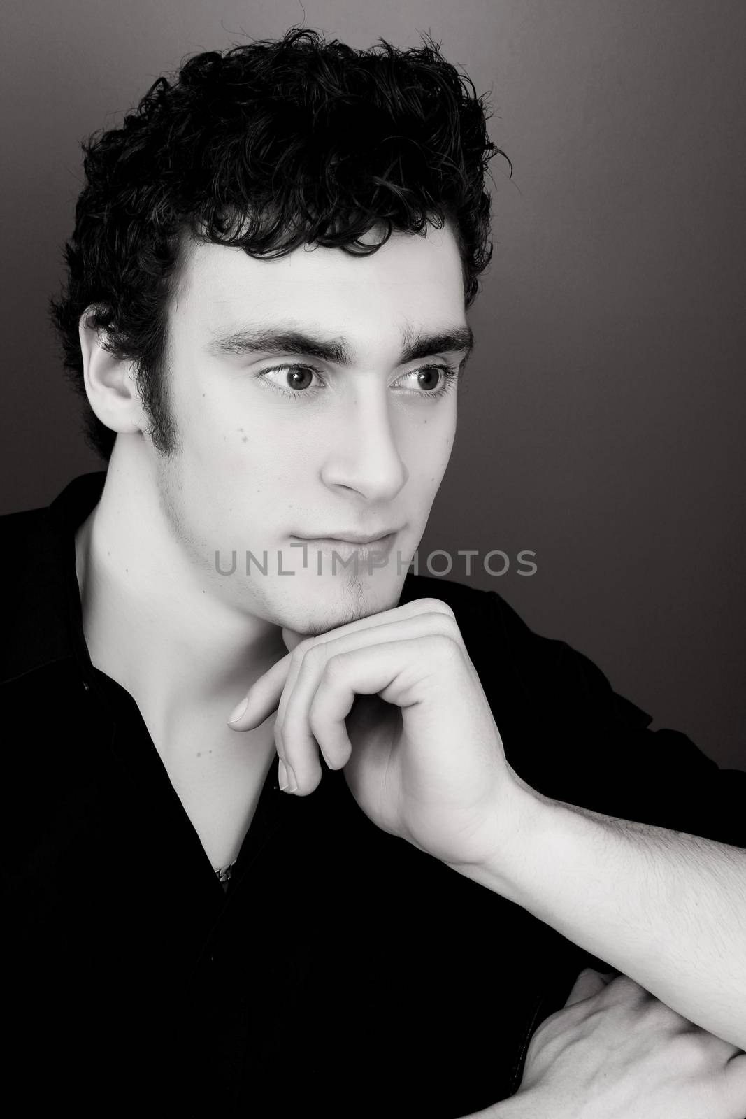 Attractive brunette male model in black dress shirt