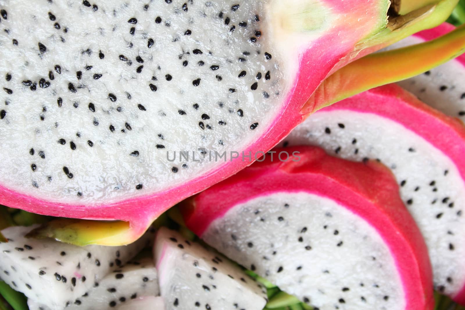 Pink pitahaya dragon fruit background sliced in pieces
