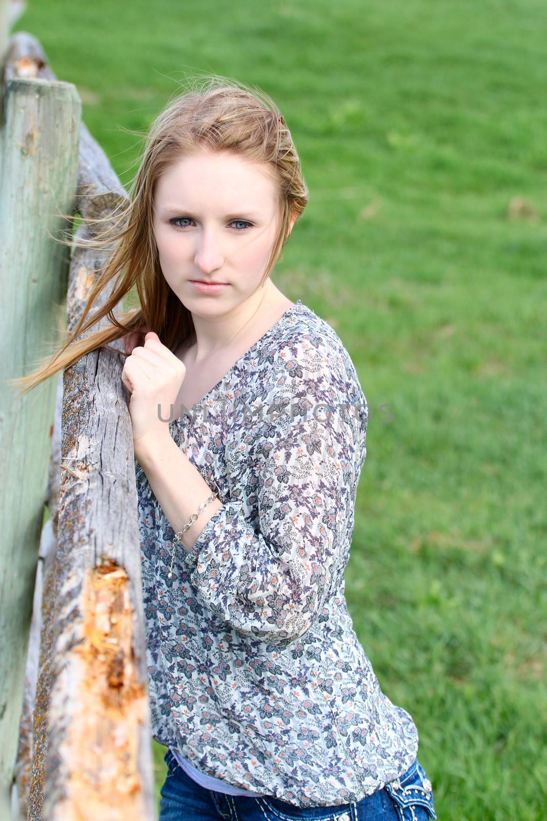 Beautiful blond model outdoors in rural setting natural light