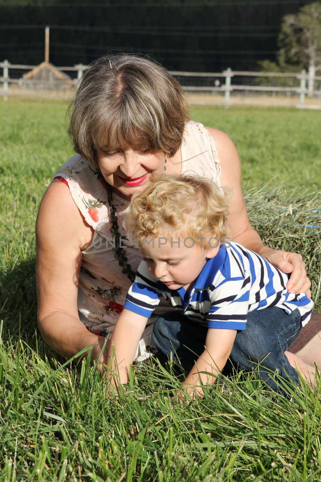 Grandmother and grandson playing outside in the field 