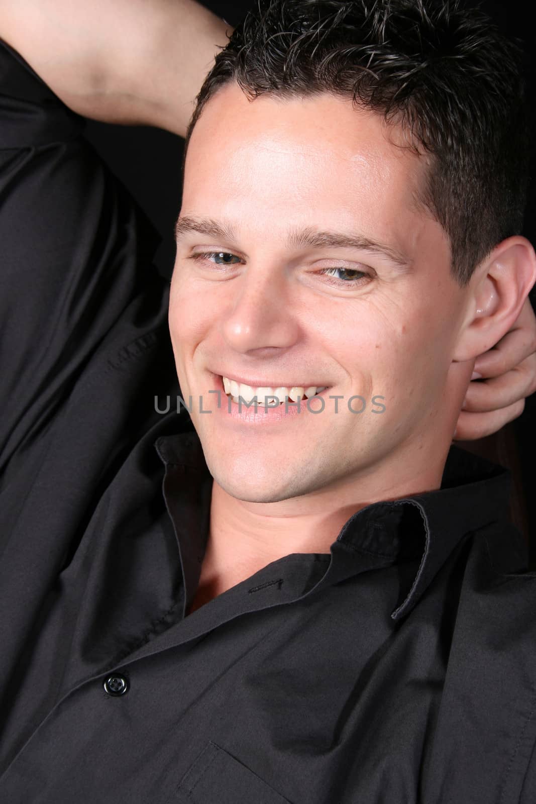 Attractive male model against a black background