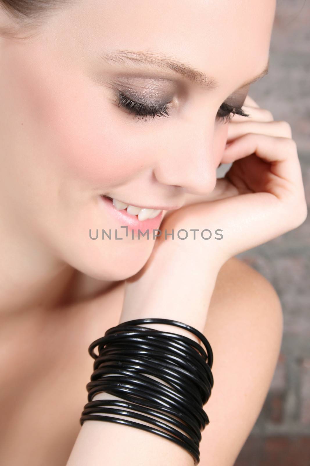 Natural beautiful blond model with black bracelets