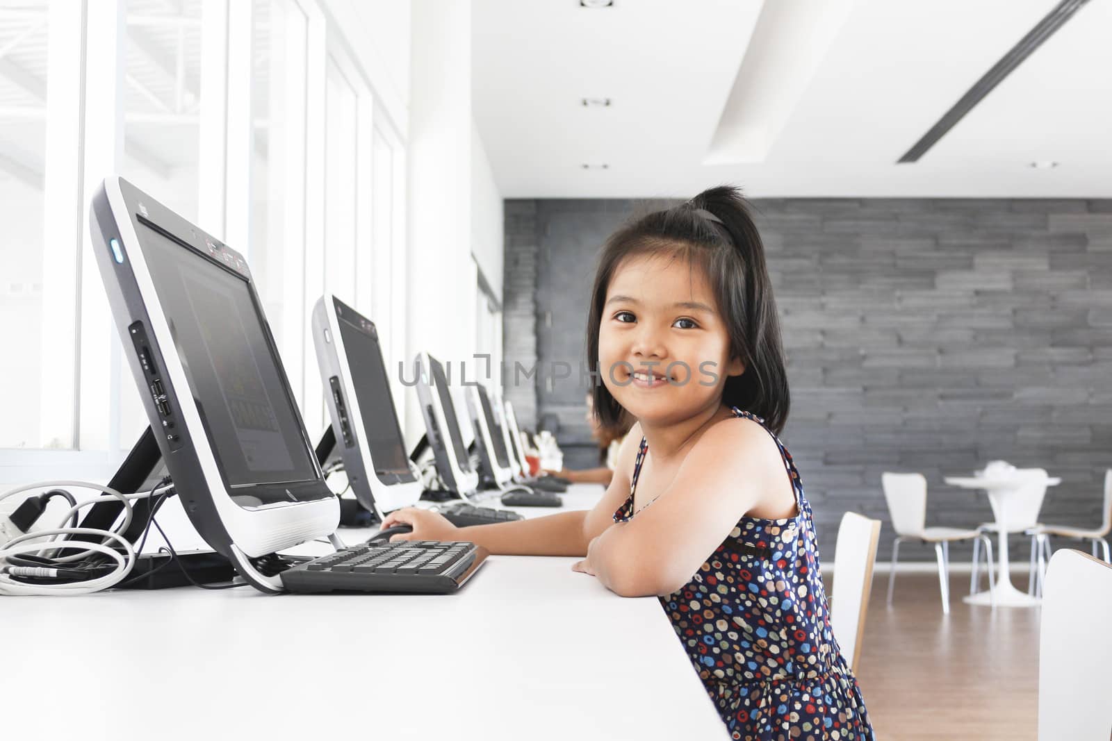 Asian children to playing with computer